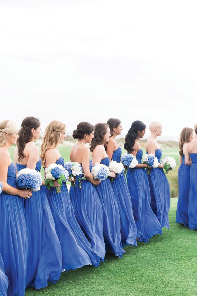 Bridesmaids At Ceremony Wearing Periwinkle Dresses And Carrying Bouquets
