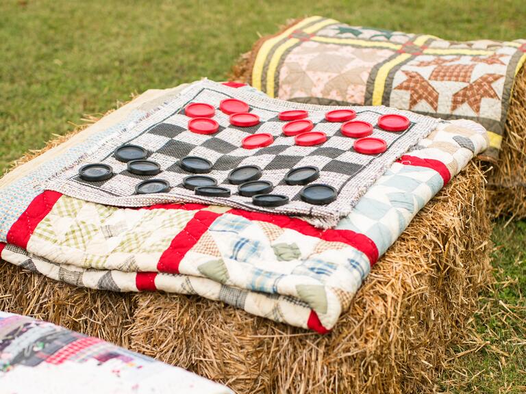 Rustic hay bale checkers at wedding reception