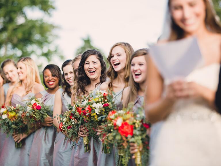 Bridesmaids laughing at ceremony vow exchange