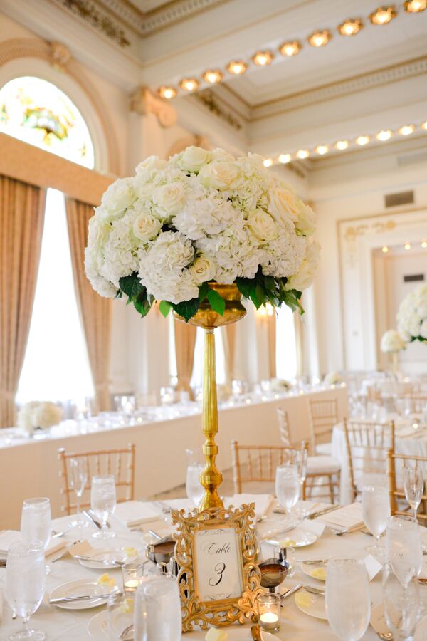 Ivory Flowers in Gold Candelabra Centerpiece