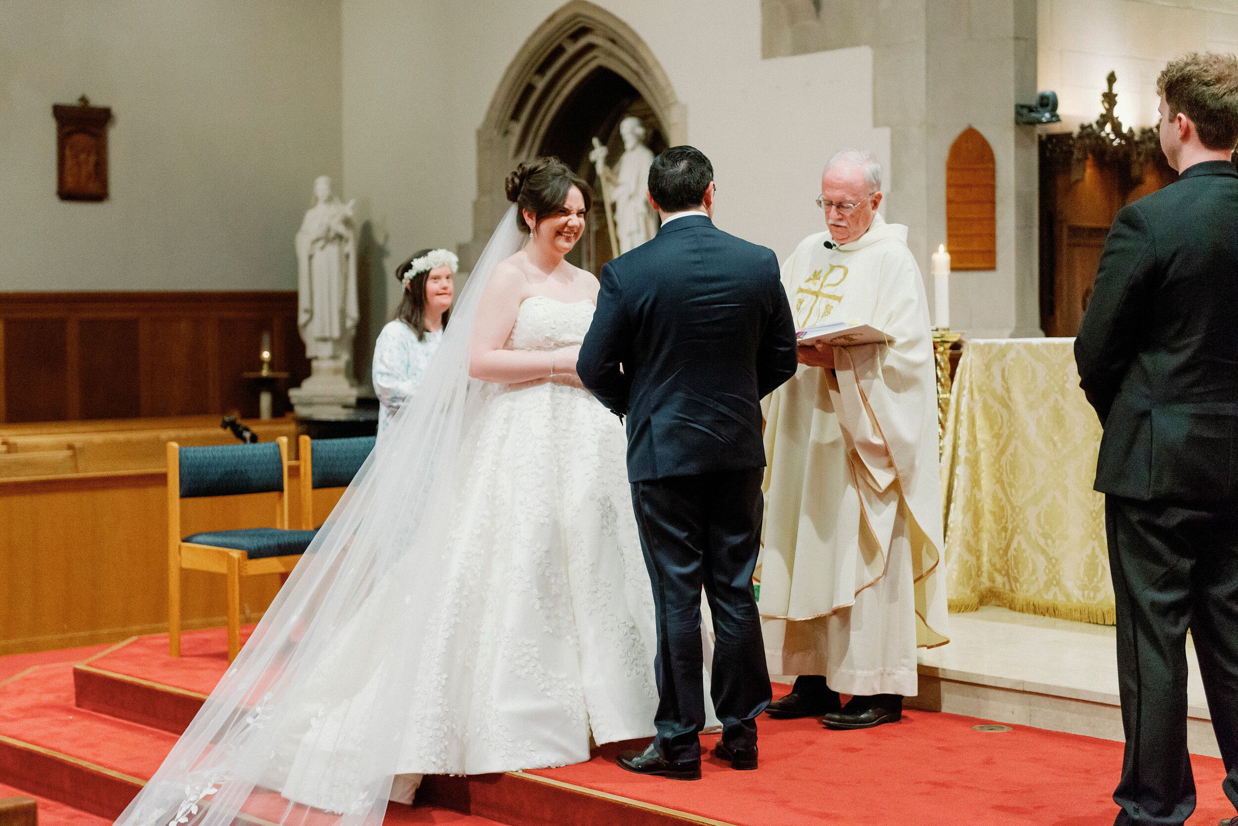 Bride With Cathedral-Length Veil Holding Hands With Groom In Tux ...