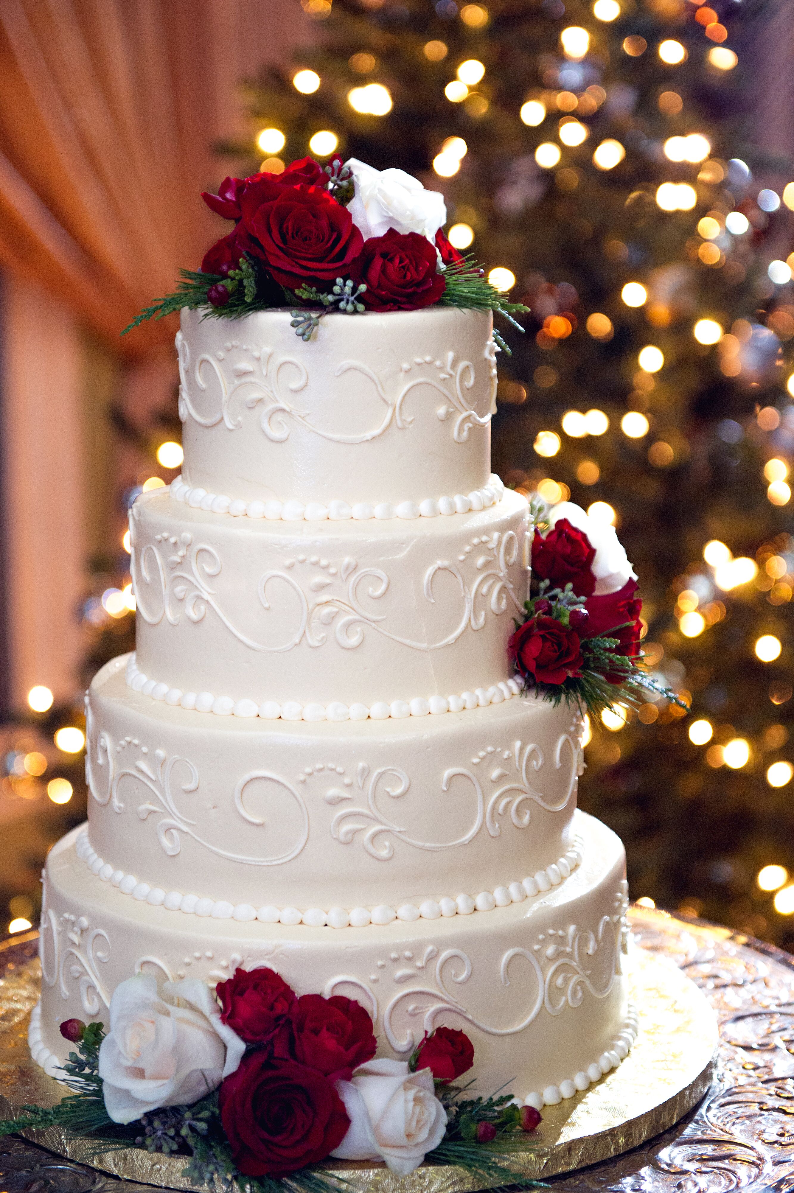 white wedding cake with red roses