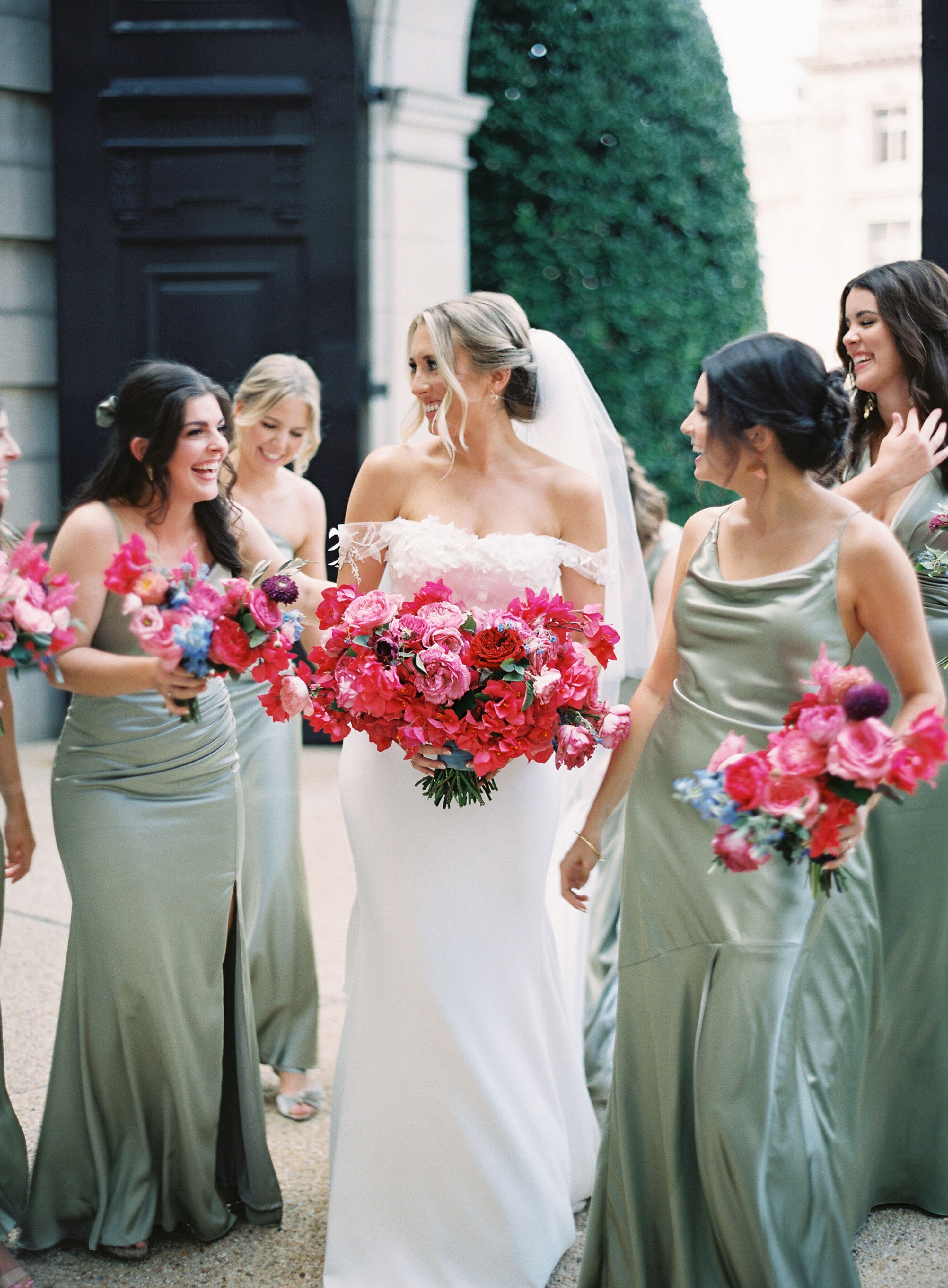 Bride and Bridesmaids in Sage Green Dresses With Pink Bouquets