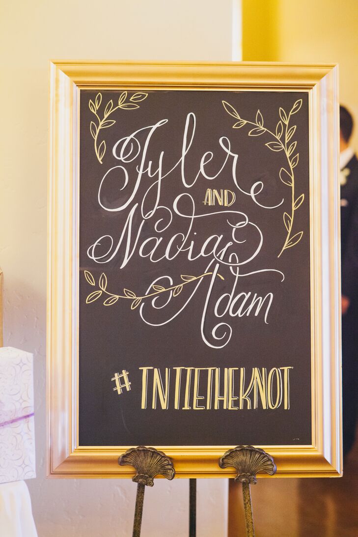 Frame-bordered chalkboard sign with wedding hashtag