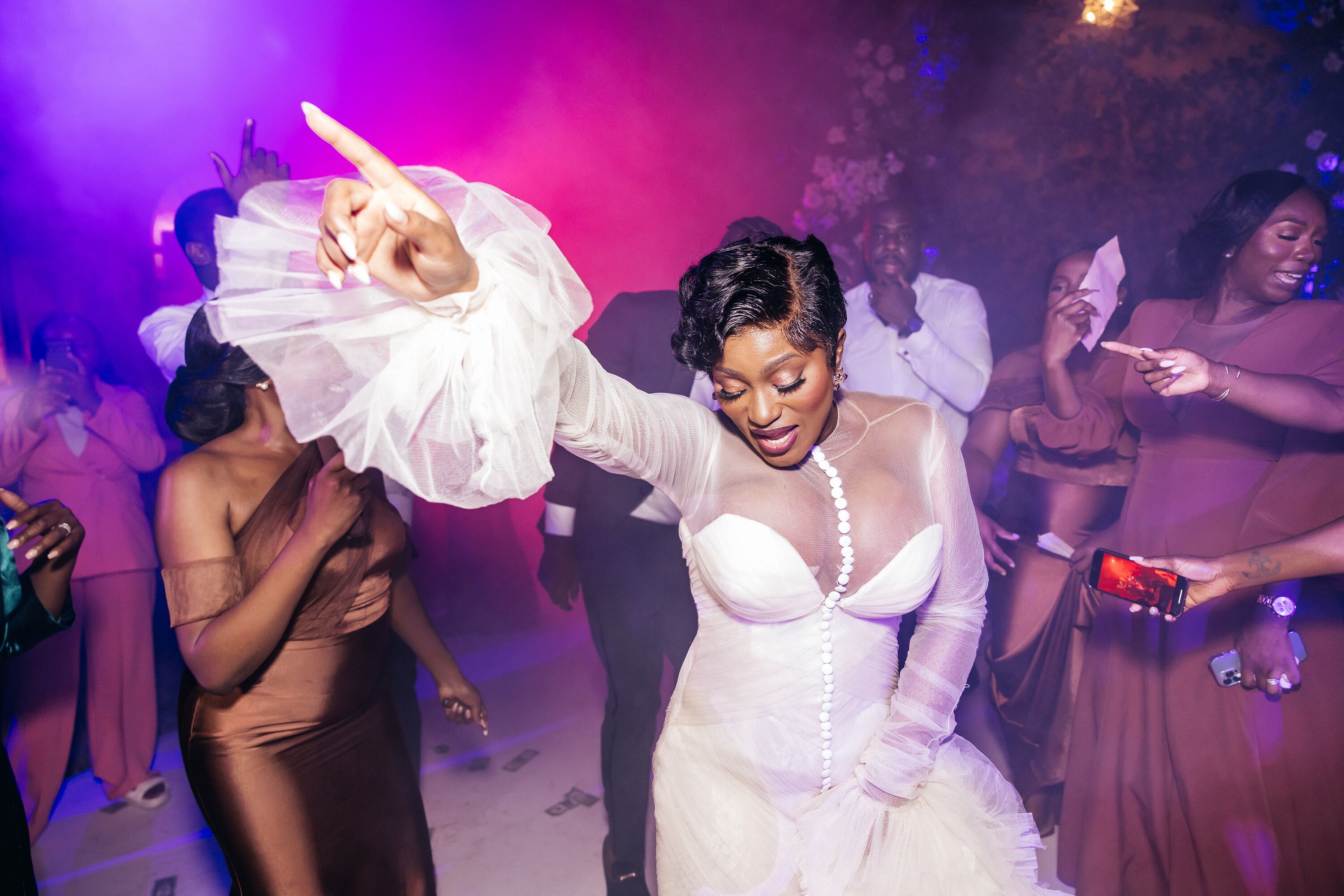 bride-in-second-dress-with-ruffled-sleeves-on-dance-floor-with-guests