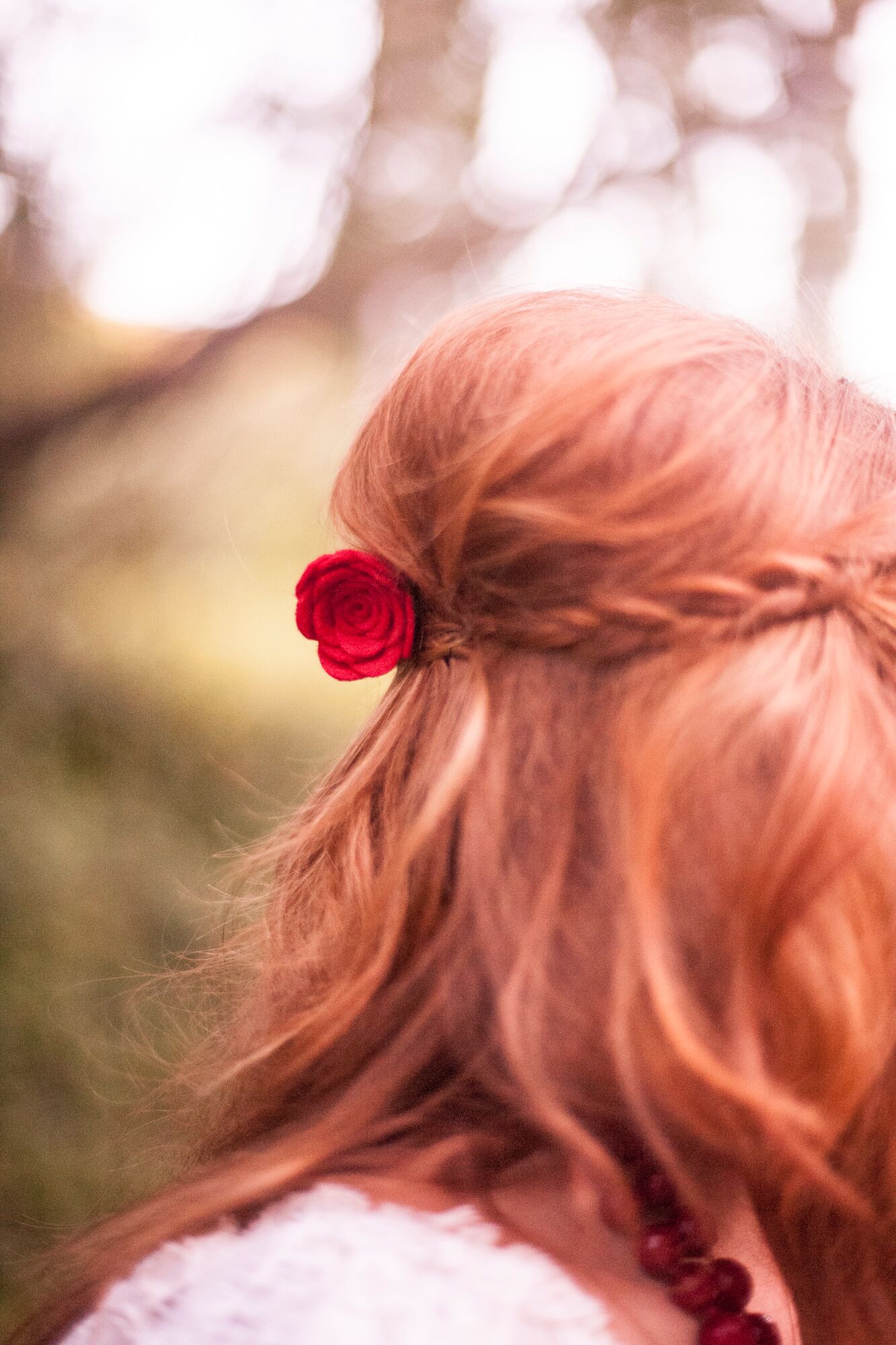 Braided Down Hairstyle With Red Rose