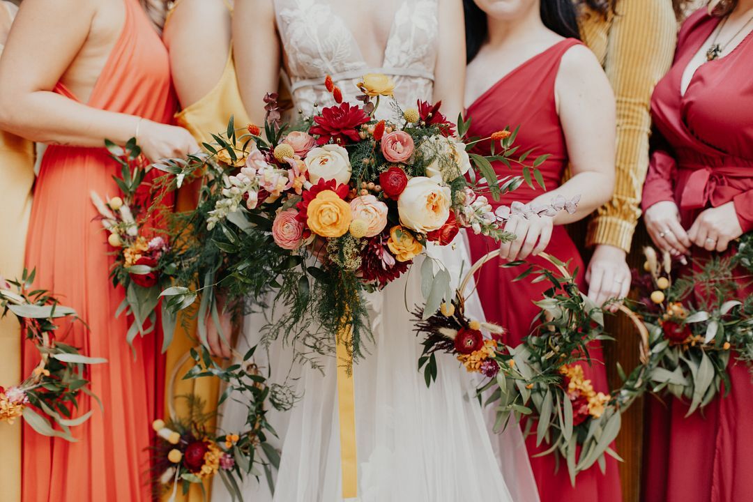 Bride and Bridesmaids With Warm-Colored Flowers