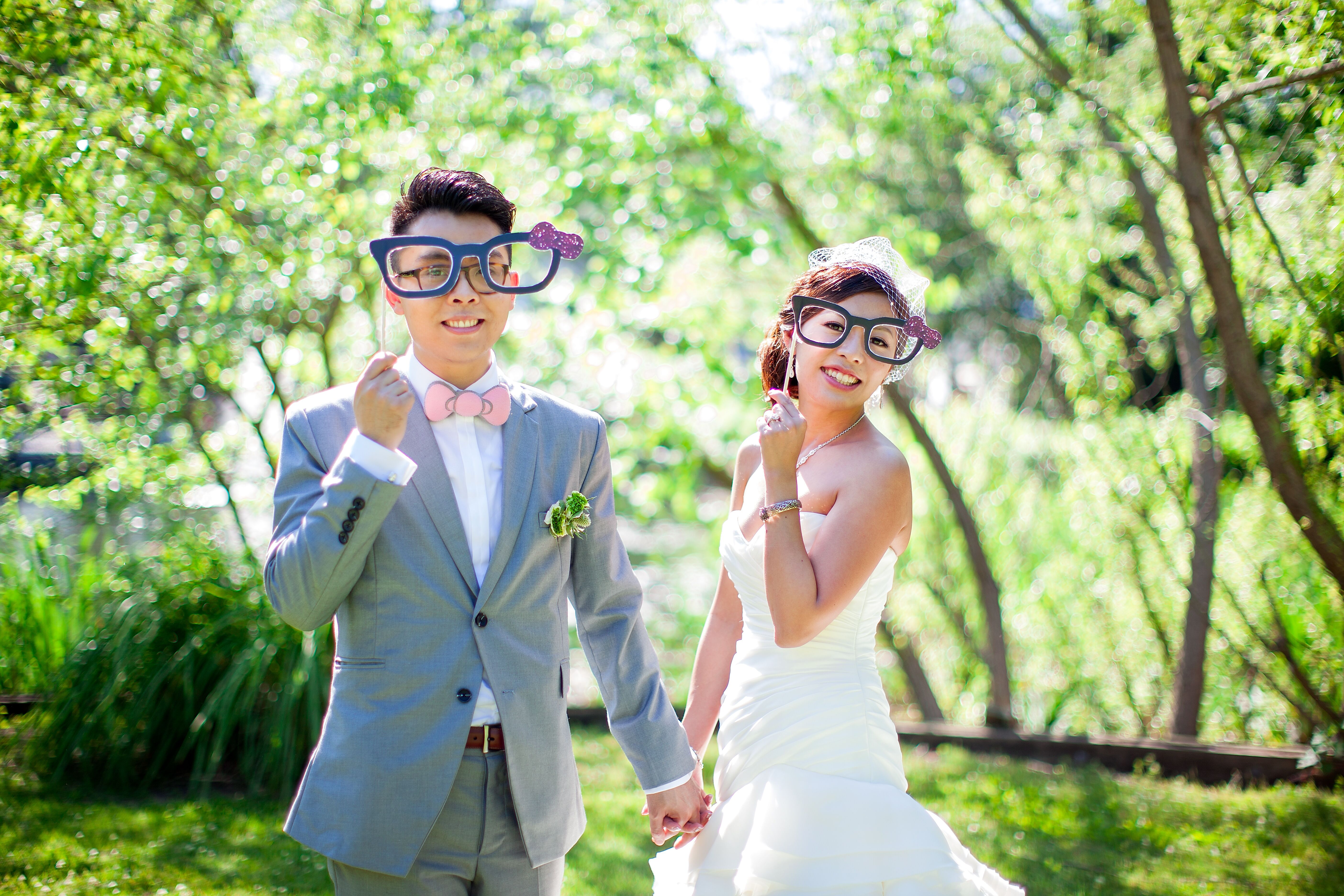 Bride and Groom Posing with Photo Booth Props