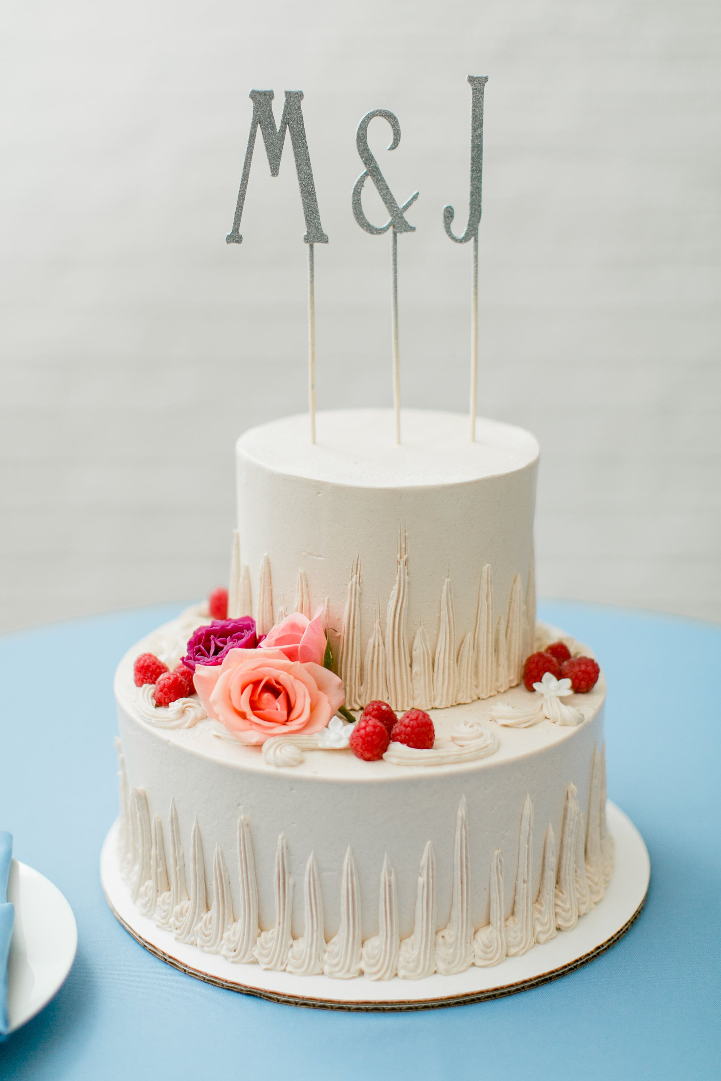 Simple Two Tier Cake With Raspberries And Pink Flowers