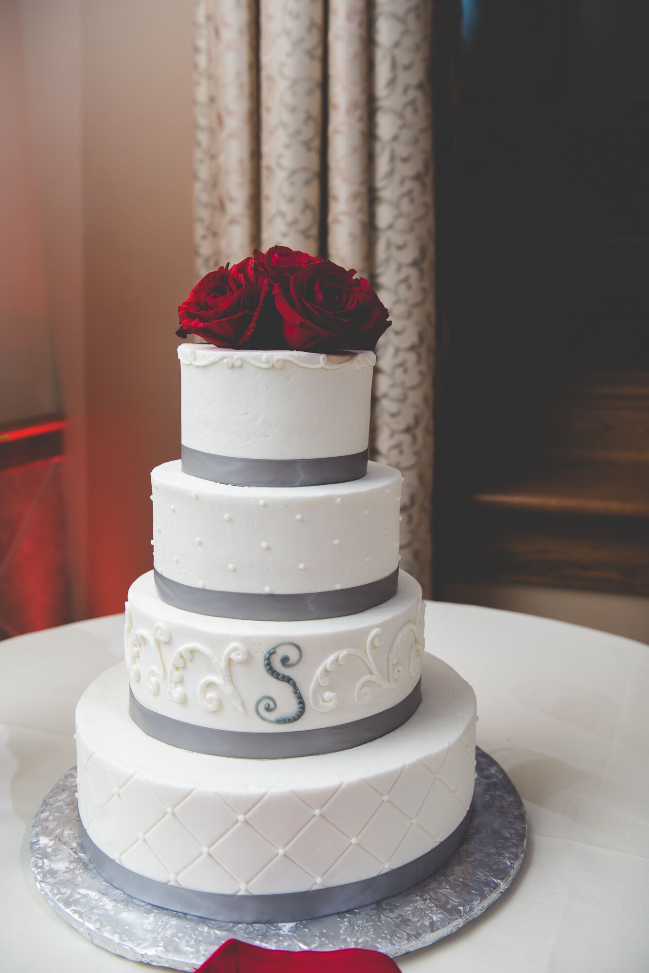 white wedding cake with red roses