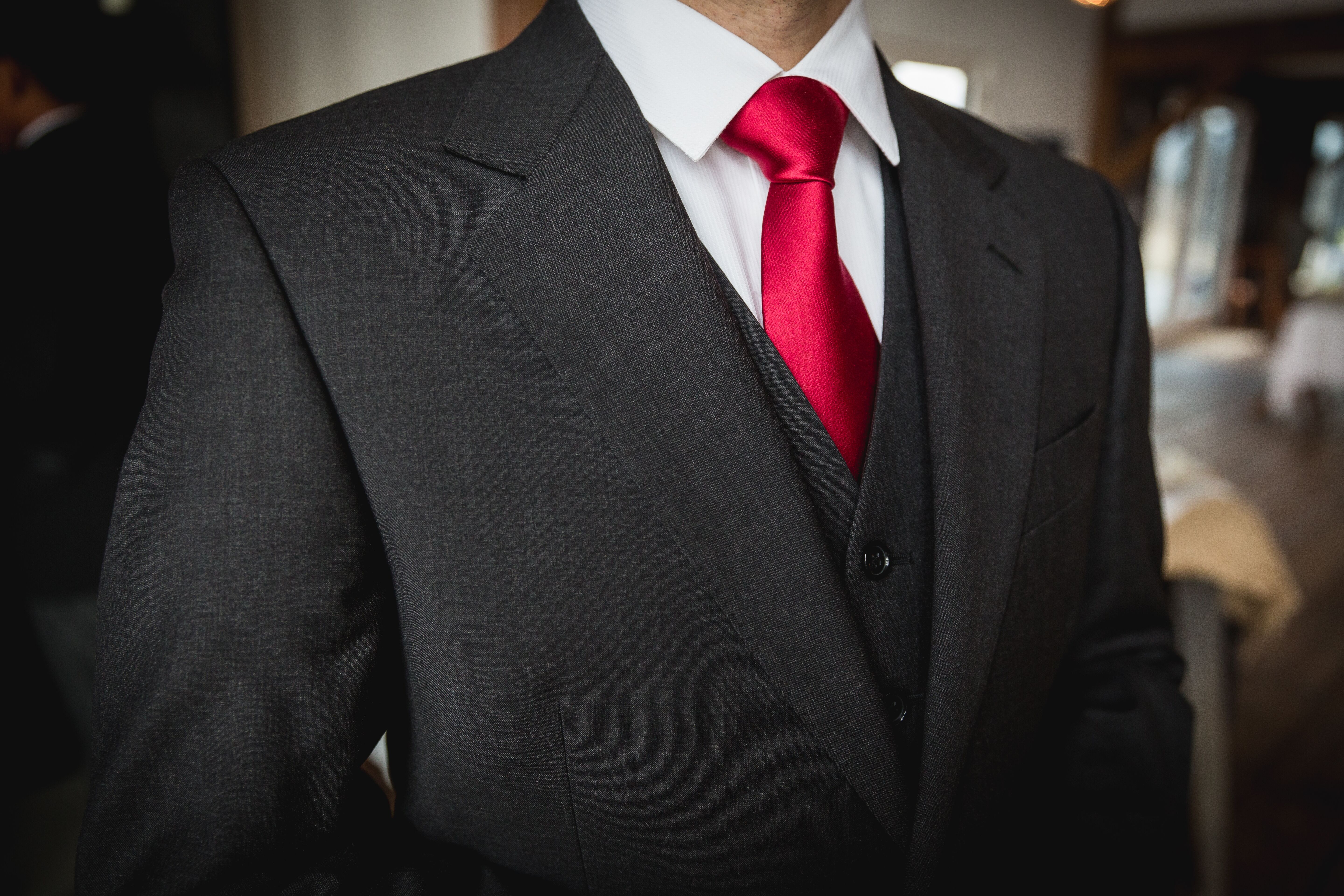 Groom's Dark Gray Three-Piece Suit with Red Tie