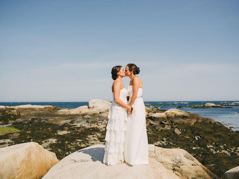 Same sex couple kissing overlooking Kennebunkport, Maine