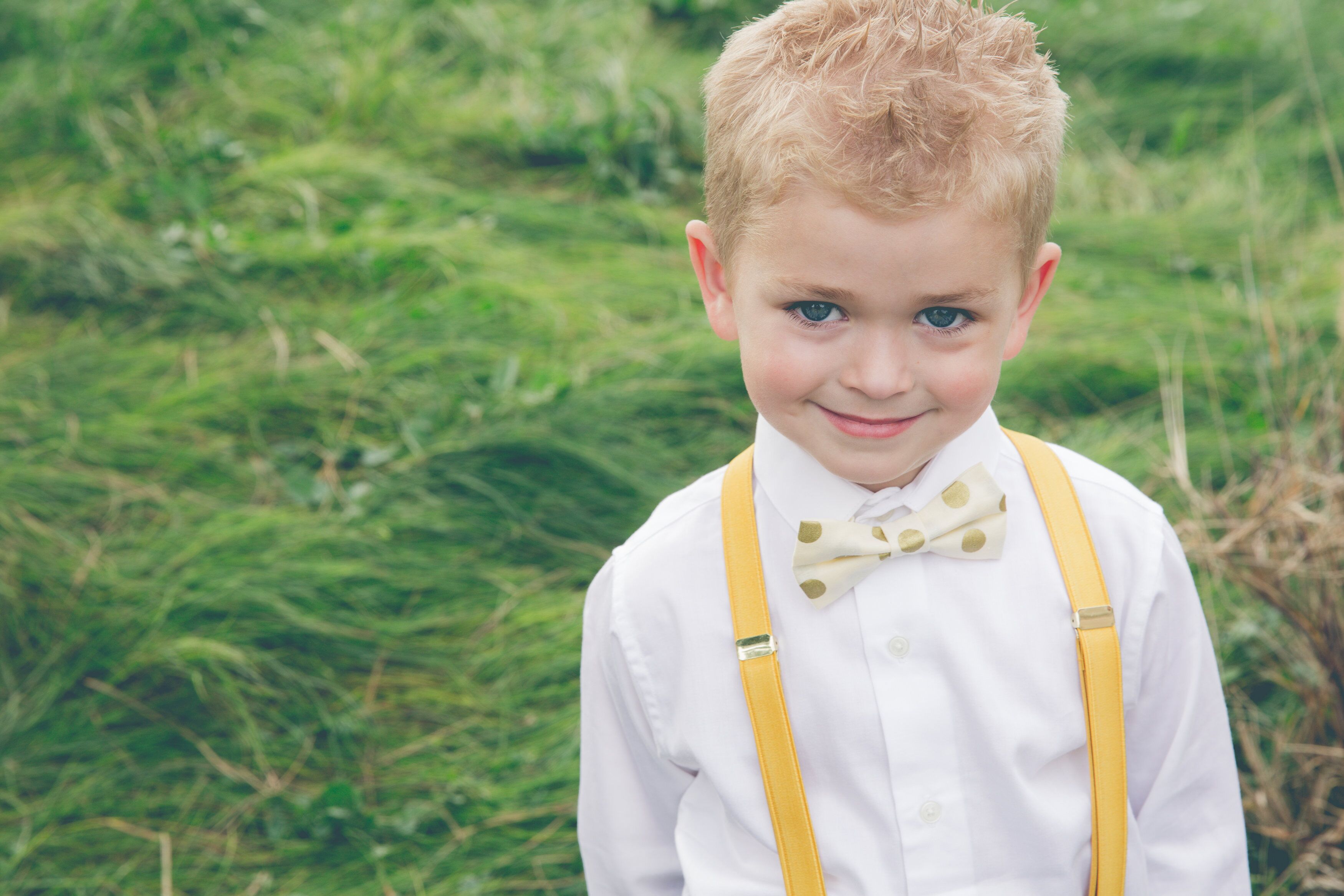 Ring Bearer in Yellow Suspenders and Bow Tie