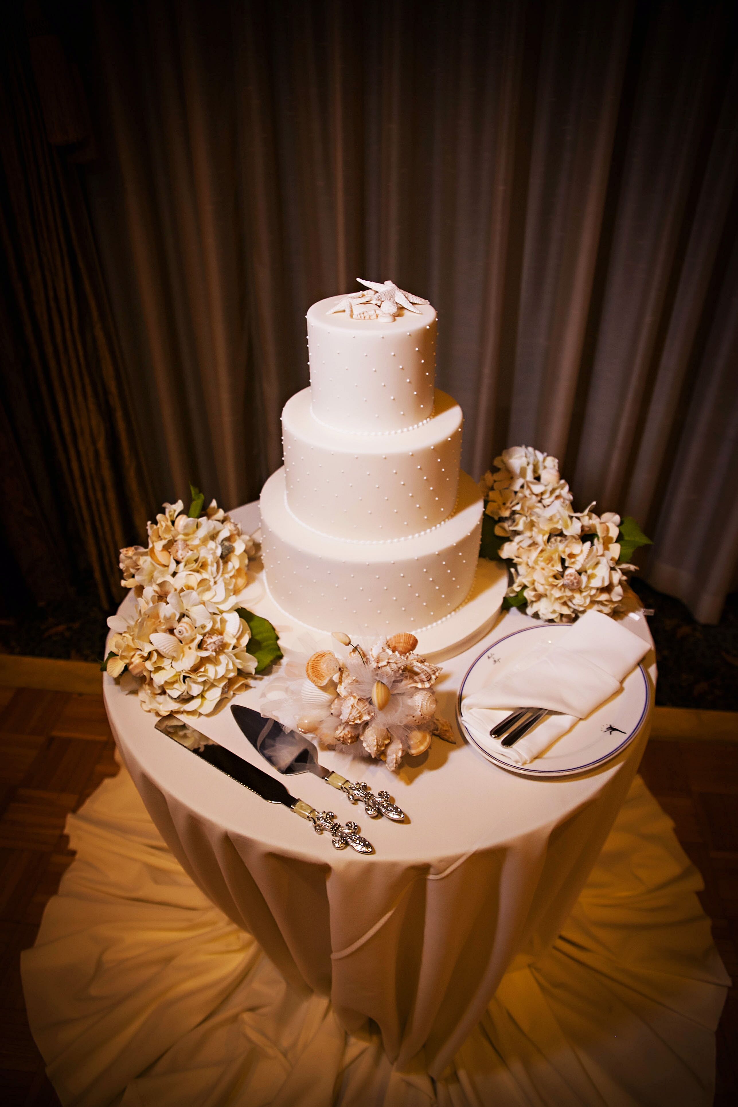 Elegant Three-Tier Starfish Topped Wedding Cake