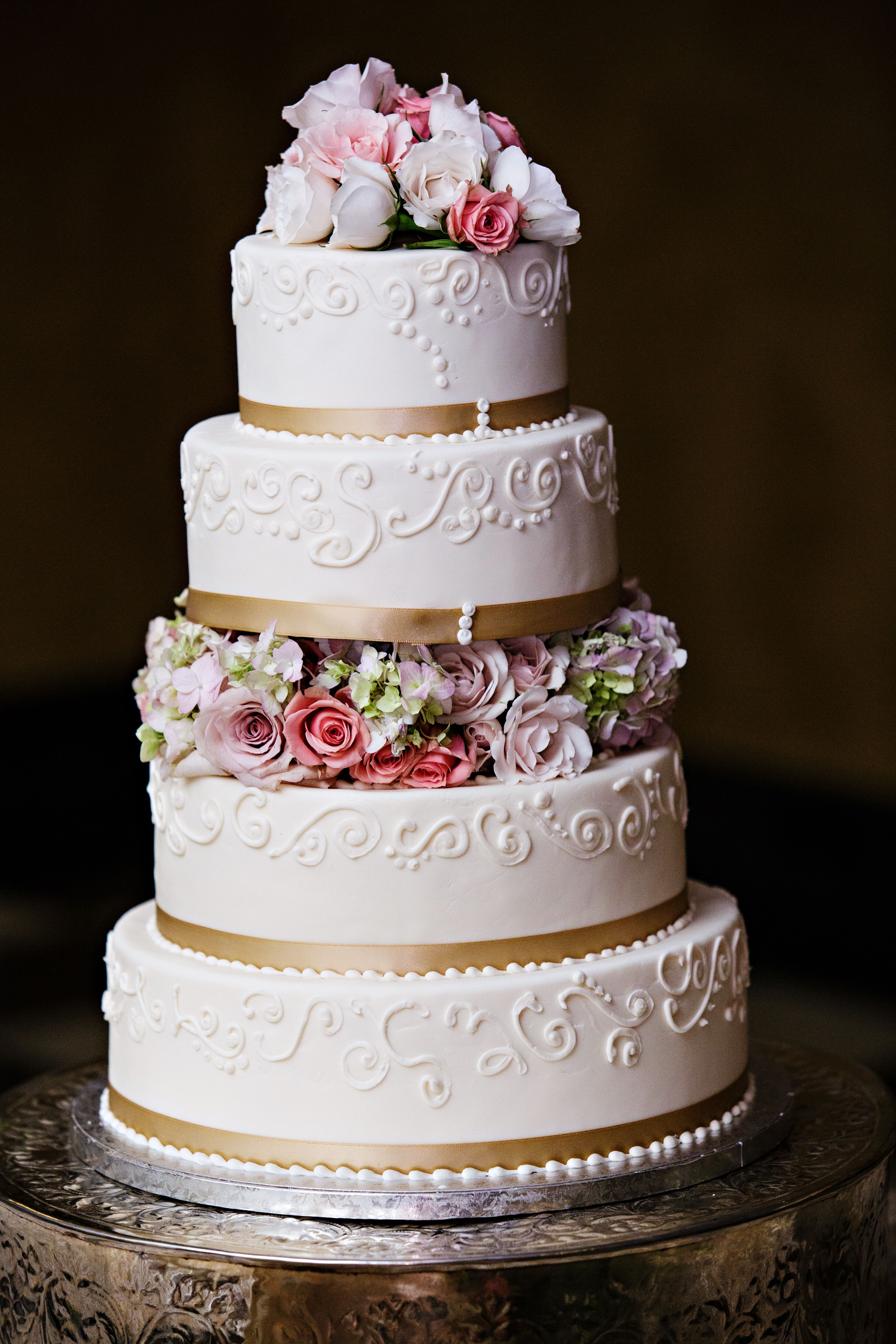 White Wedding Cake With Gold Ribbon And Flowers