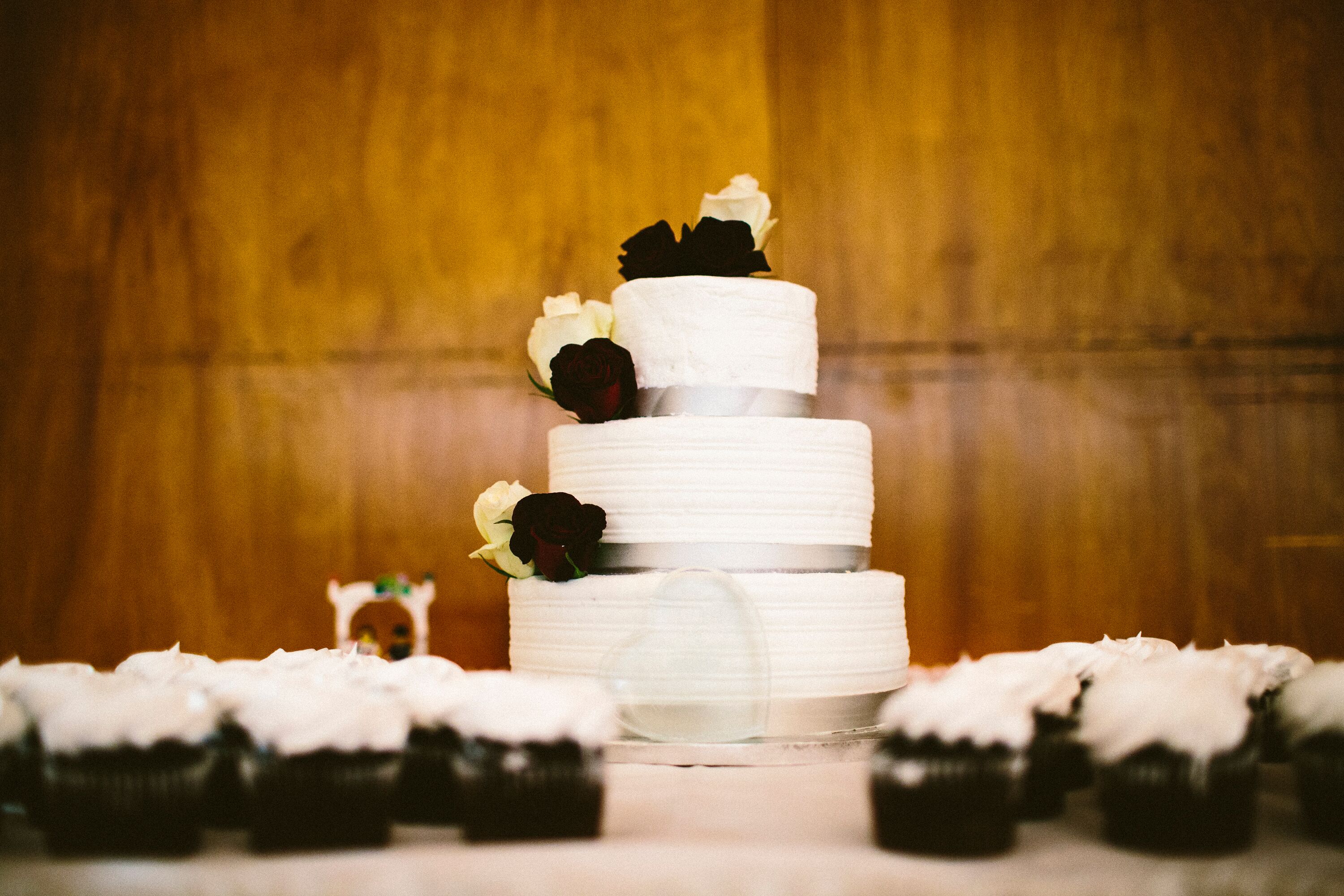 Classic White Wedding Cake With Dark Blossoms 