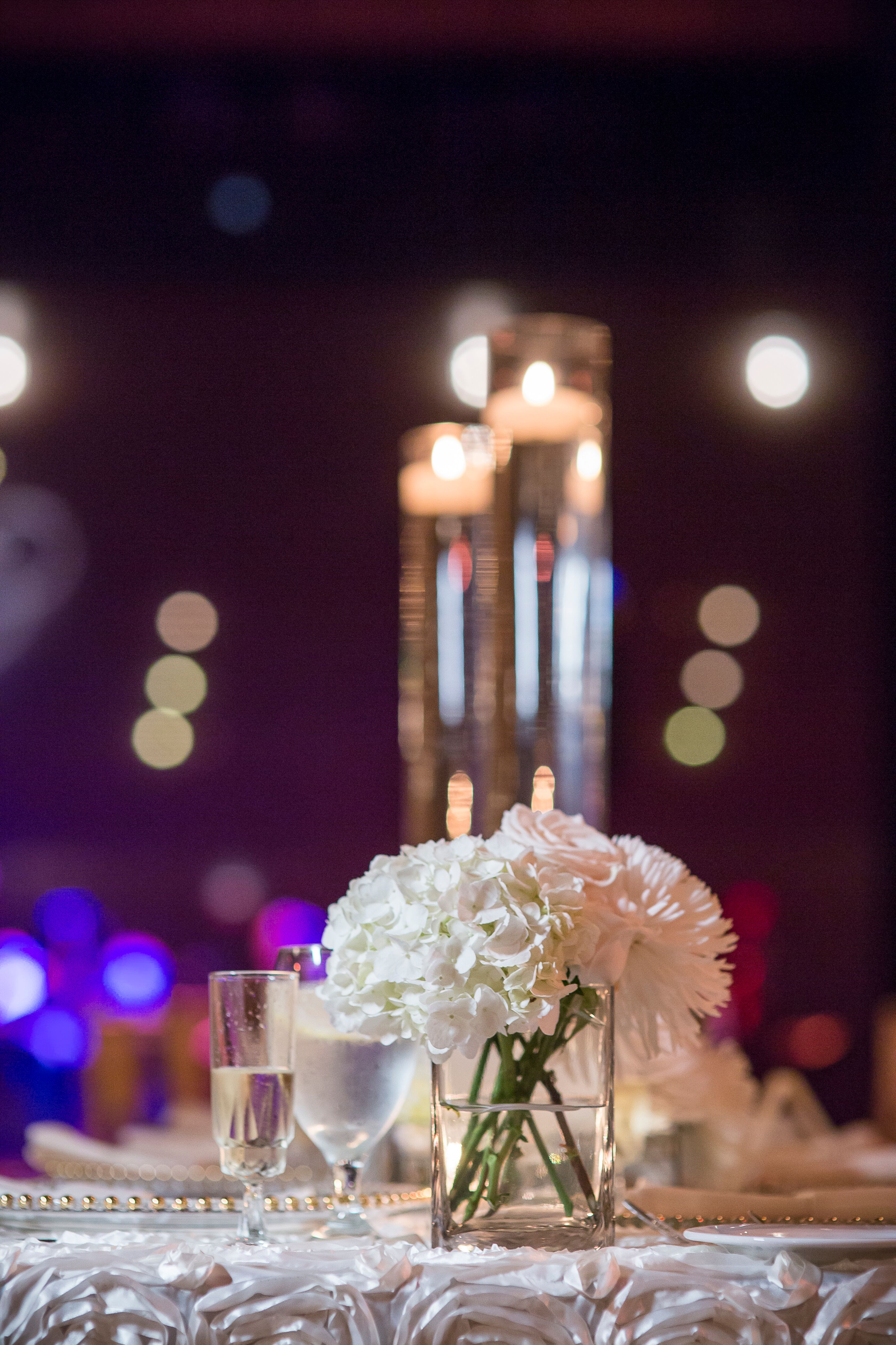 Floating Candles and Small White Flower Arrangements