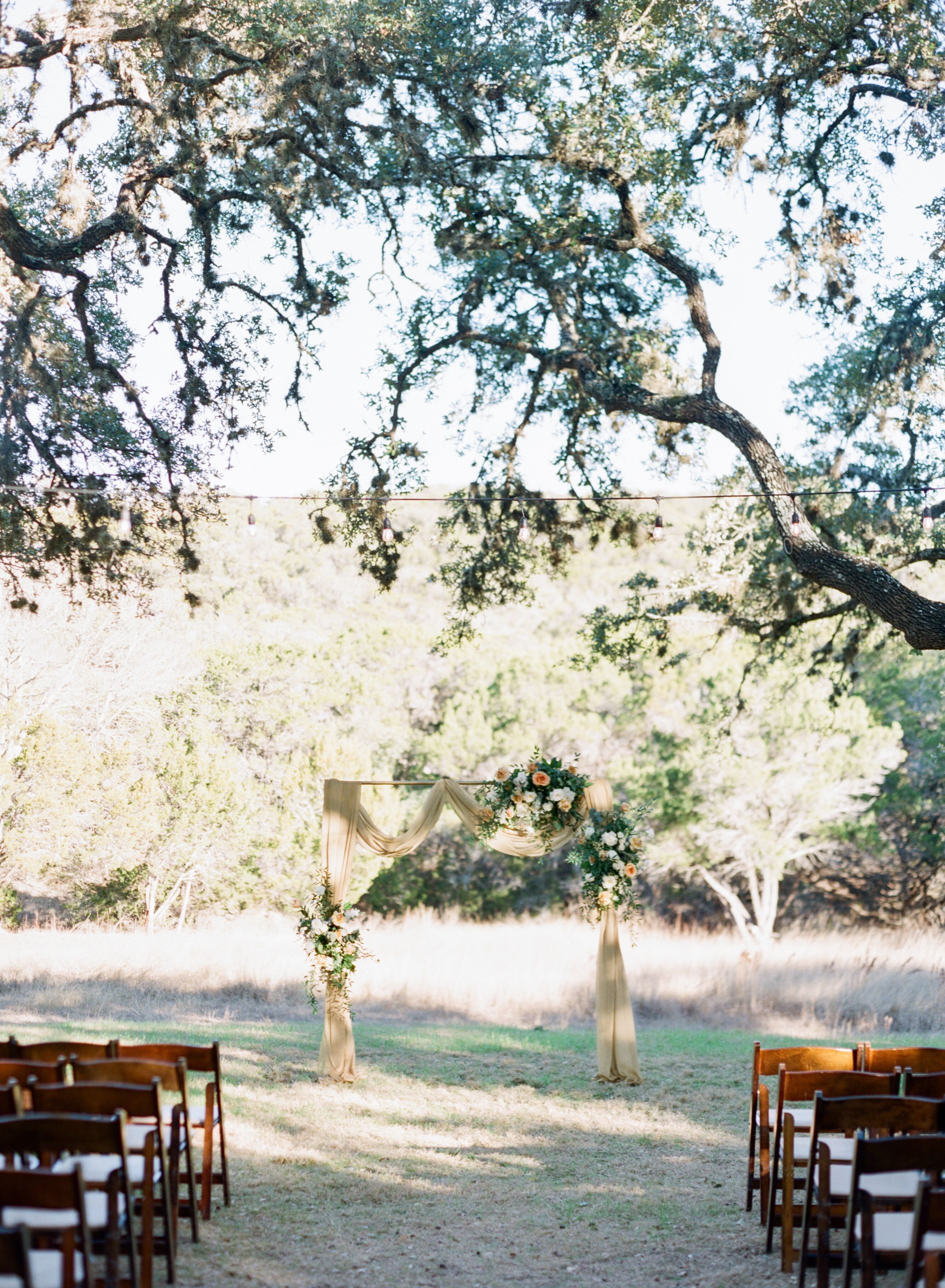 Ceremony Arch with Yellow Draping at The Ivory Oak in ...