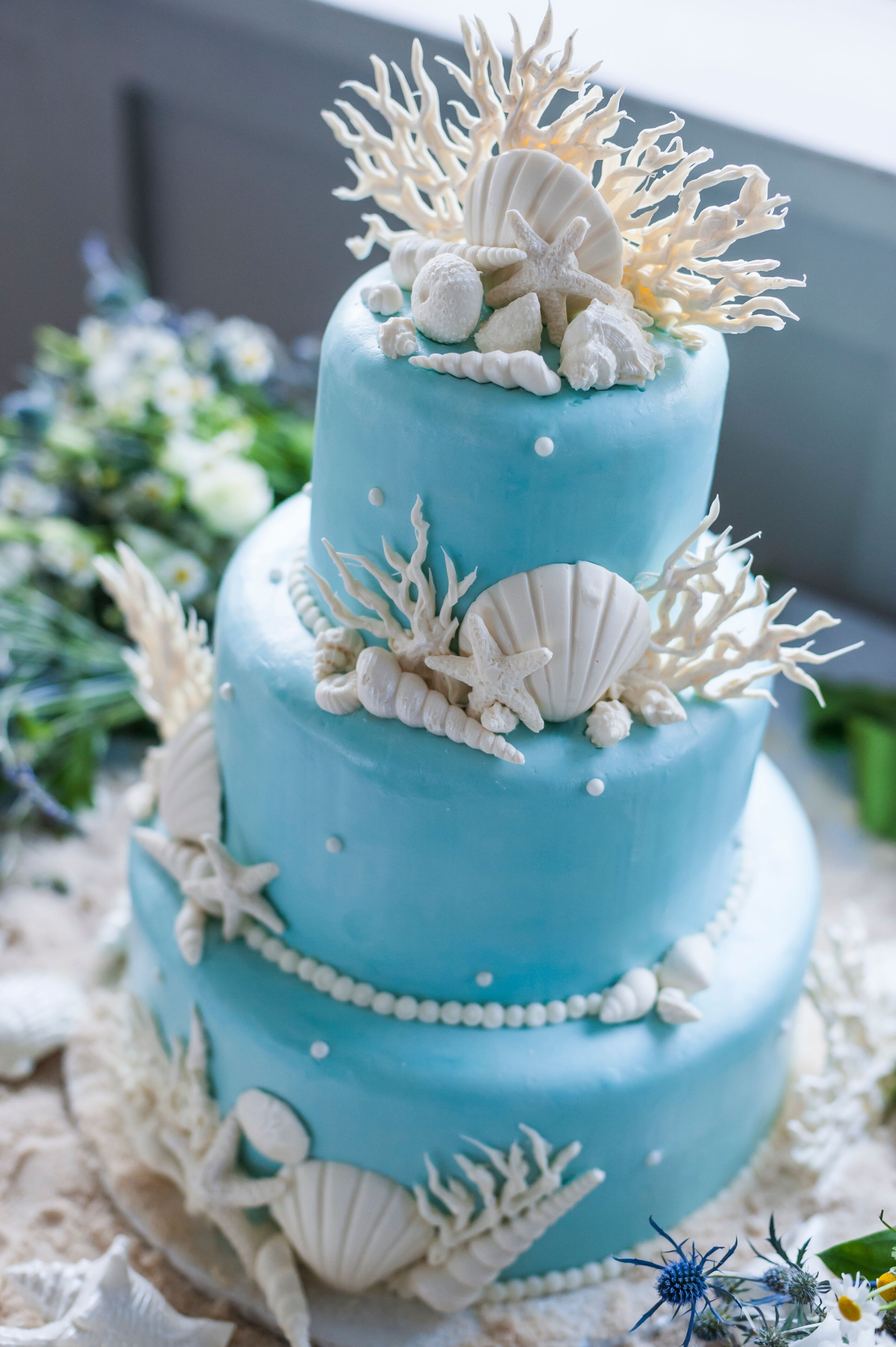 White Seashell and Coral-Decorated Blue Wedding Cake