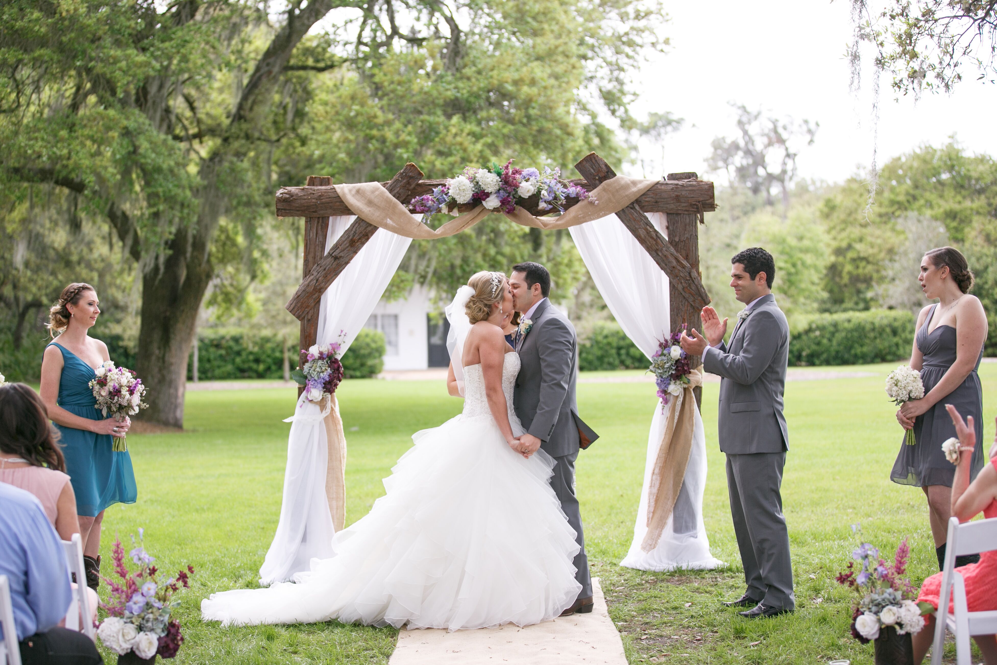 Check out this rustic wedding arch with draped burlap and see more inspirat...