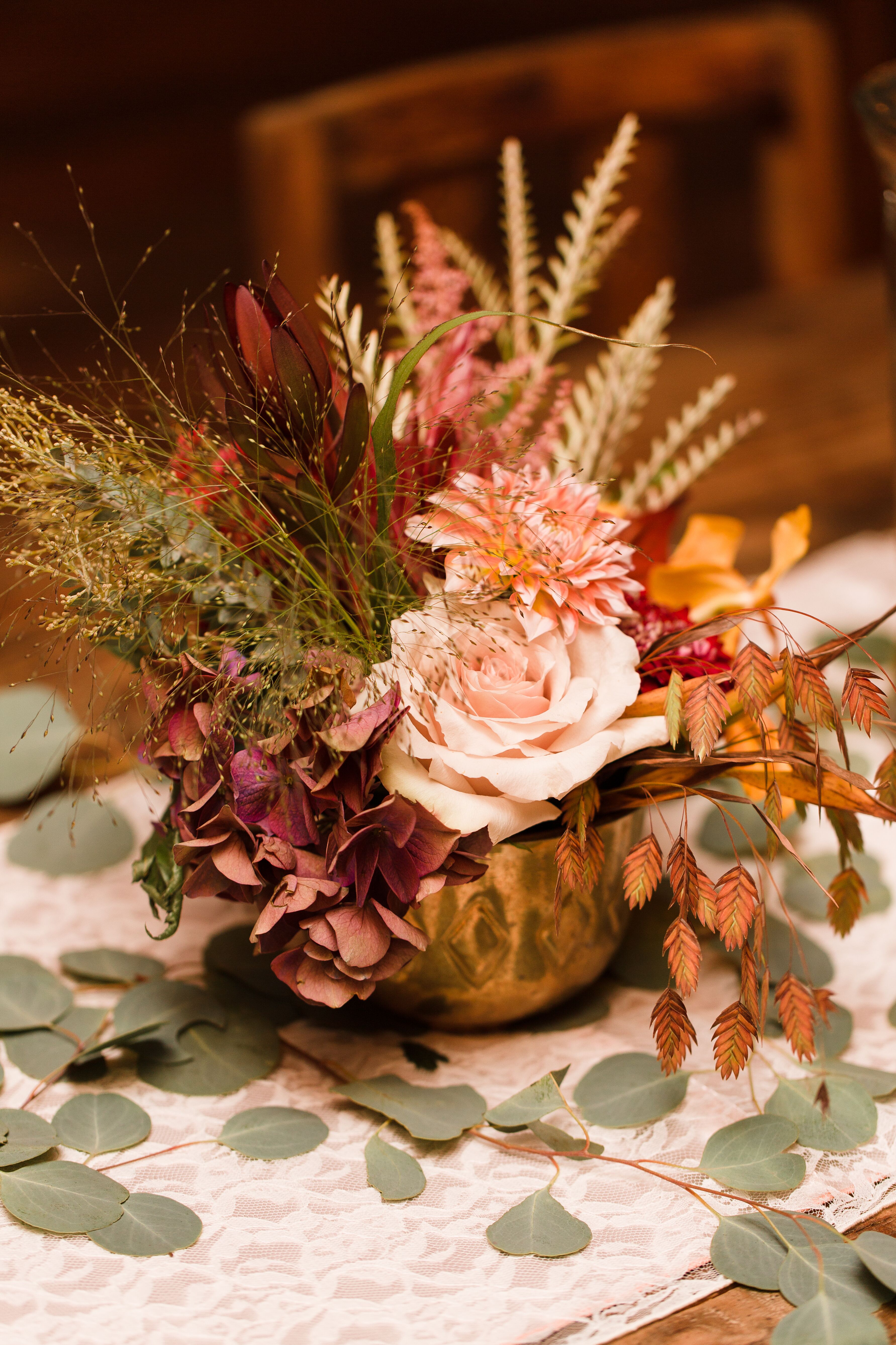 Fall Foliage And Flower Centerpiece In Gold Vase