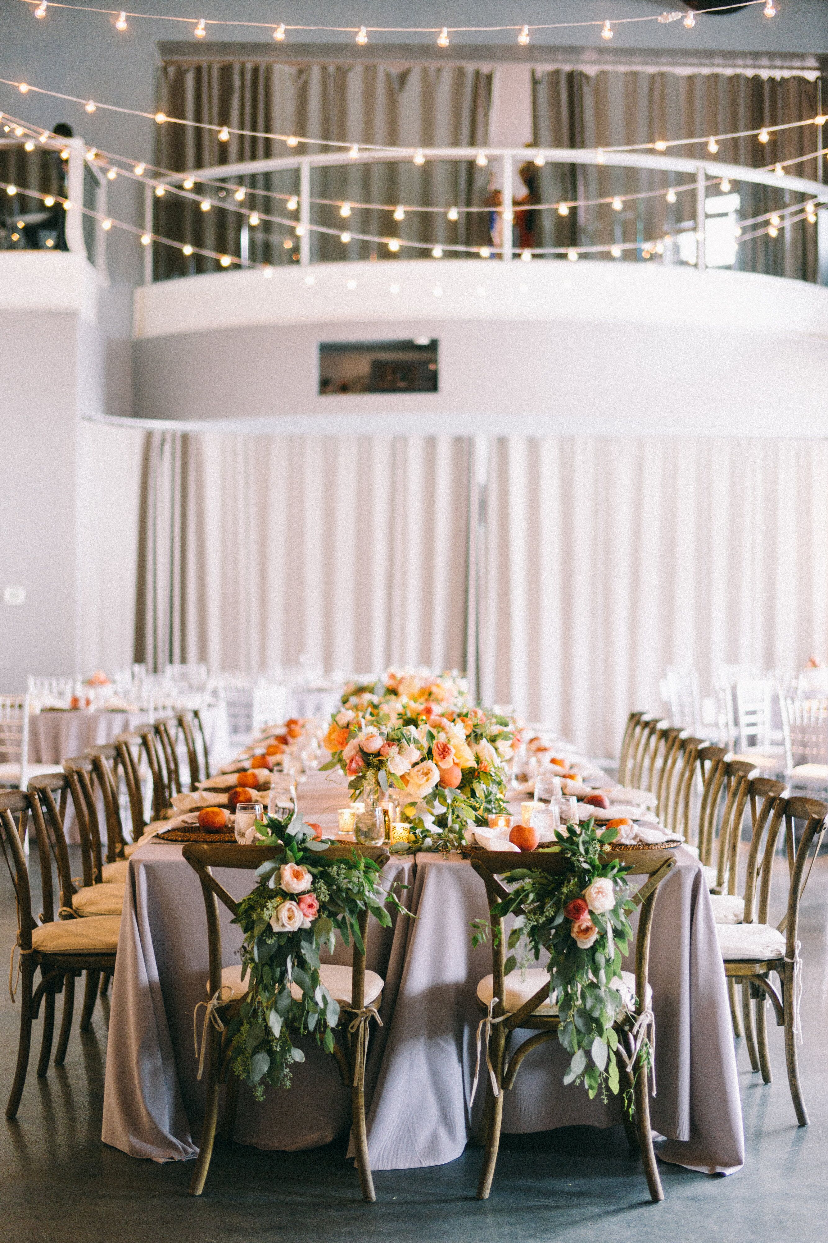 Cross Back Sweetheart Chairs With Boho Floral And Eucalyptus Swags