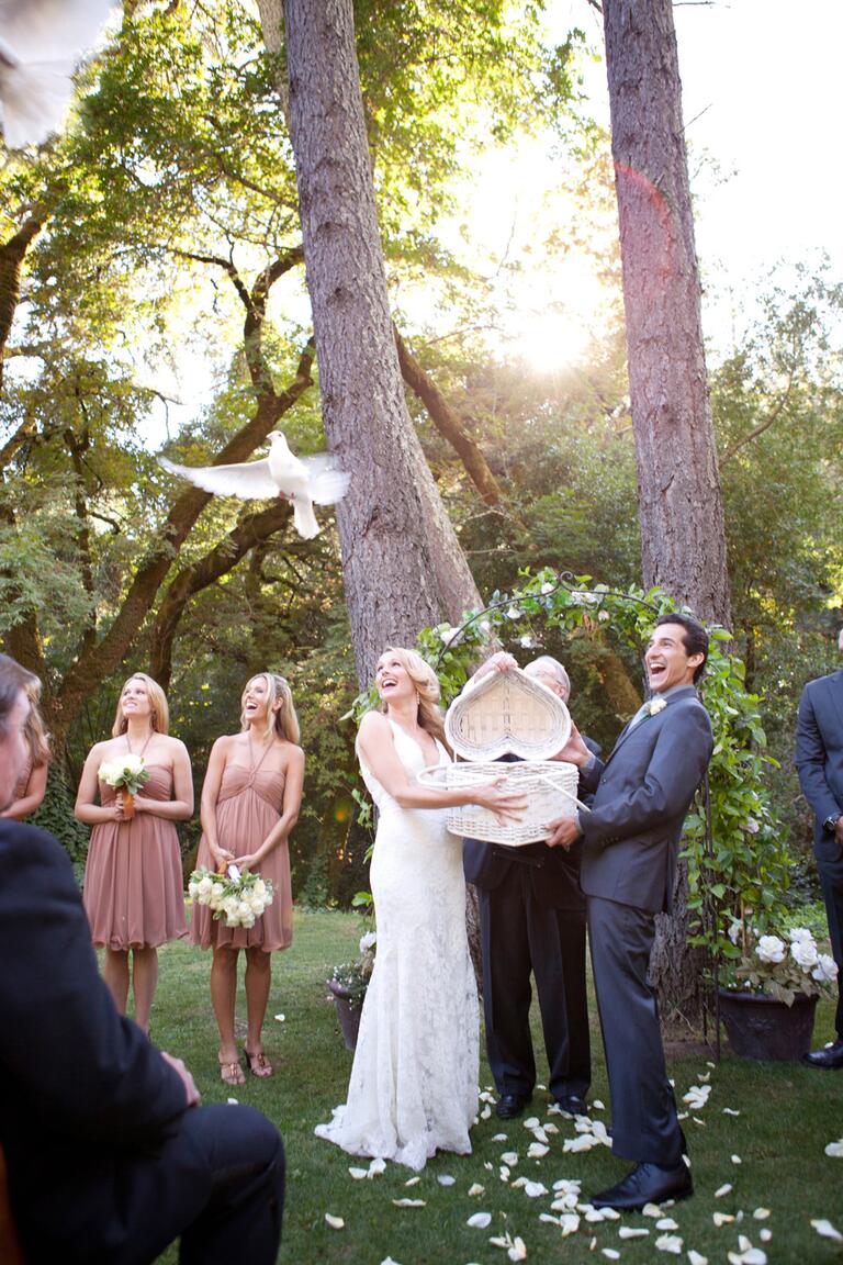 Bride and groom releasing doves