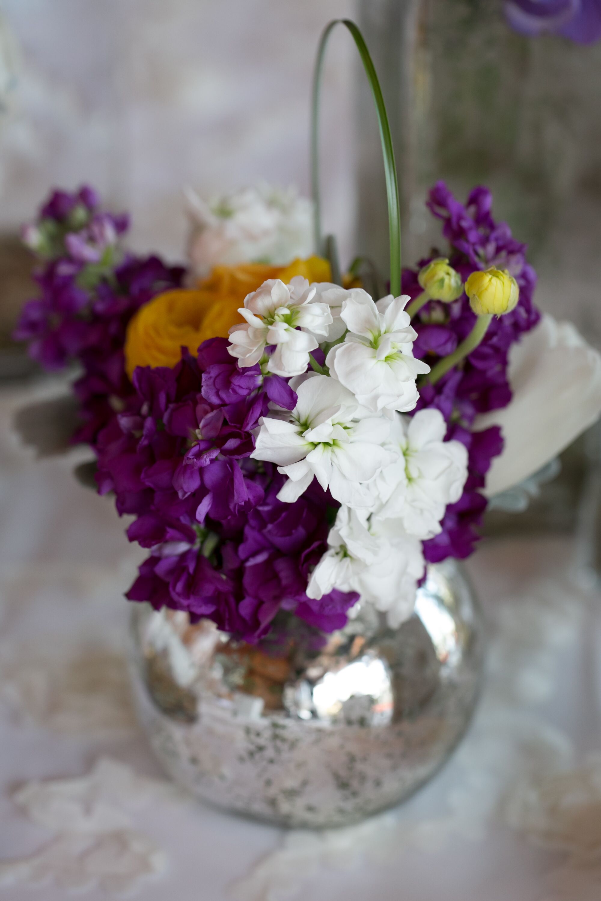 Purple And White Flower Arrangement In Silver Vase