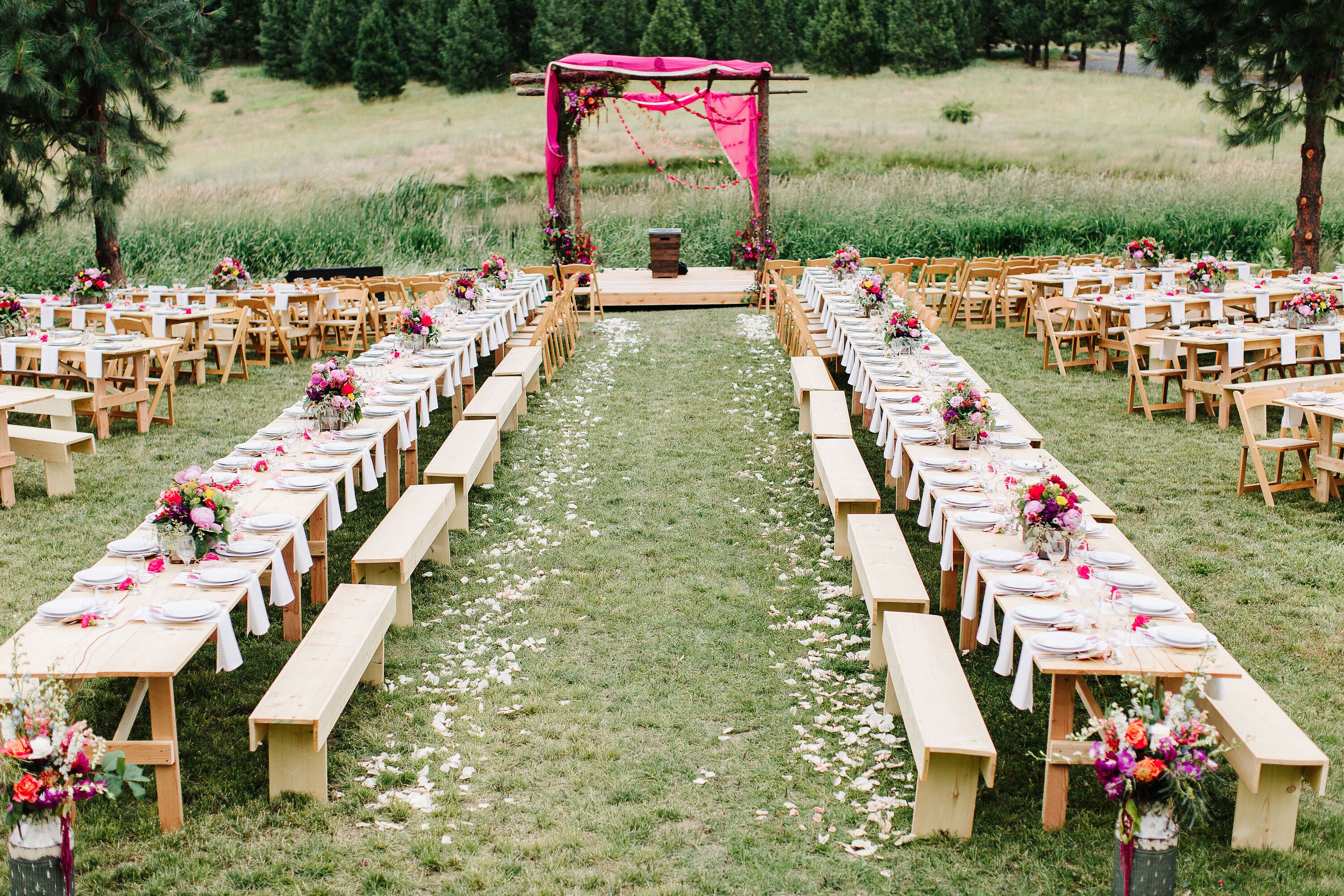 Casual Outdoor Reception with Wood Benches and Colorful Centerpieces