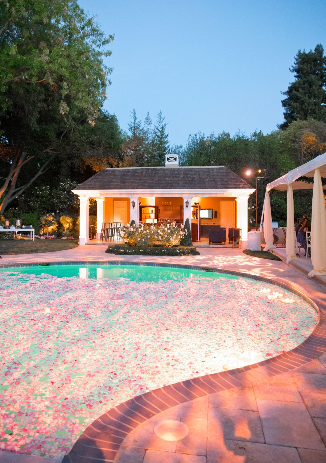 Candles And Rose Petals Decorating The Pool