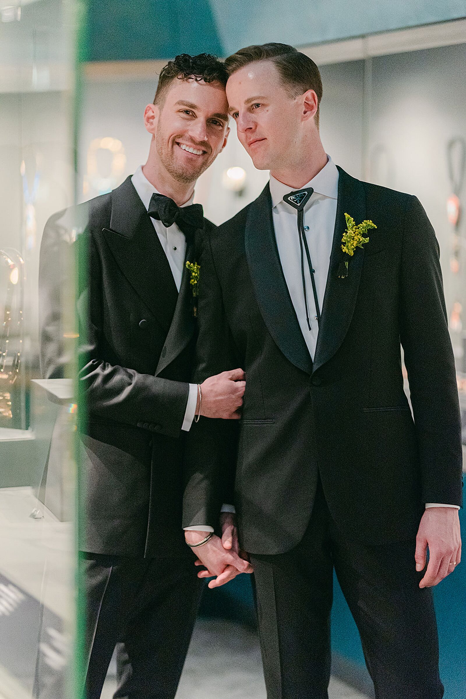 Grooms in Black Tuxedos, Greenery-and-Yellow Boutonniere and Bolo, Bow Tie