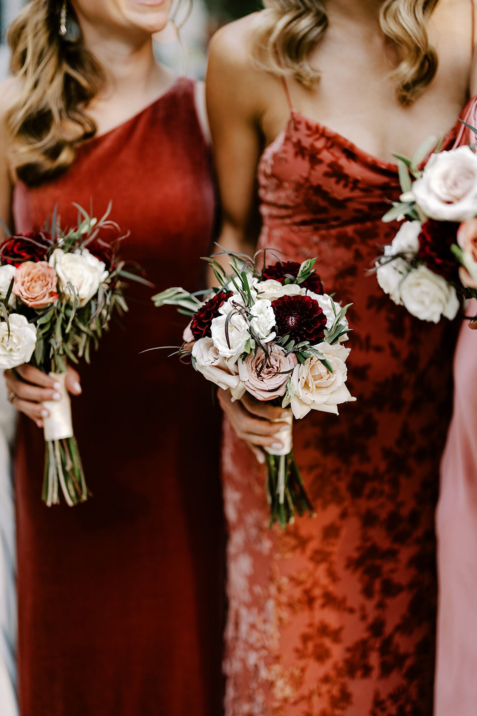 Bridesmaids in Different Red Dresses With Small Bouquets of White, Red ...