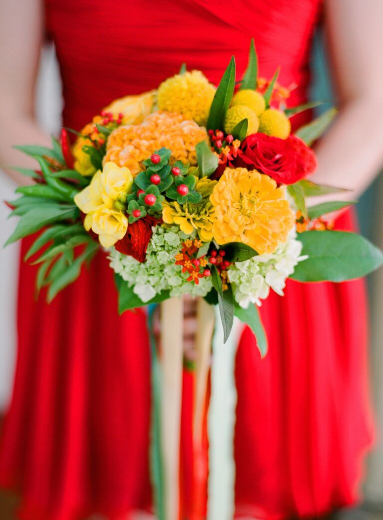 Yellow bridesmaid bouquet with red bridesmaid dress