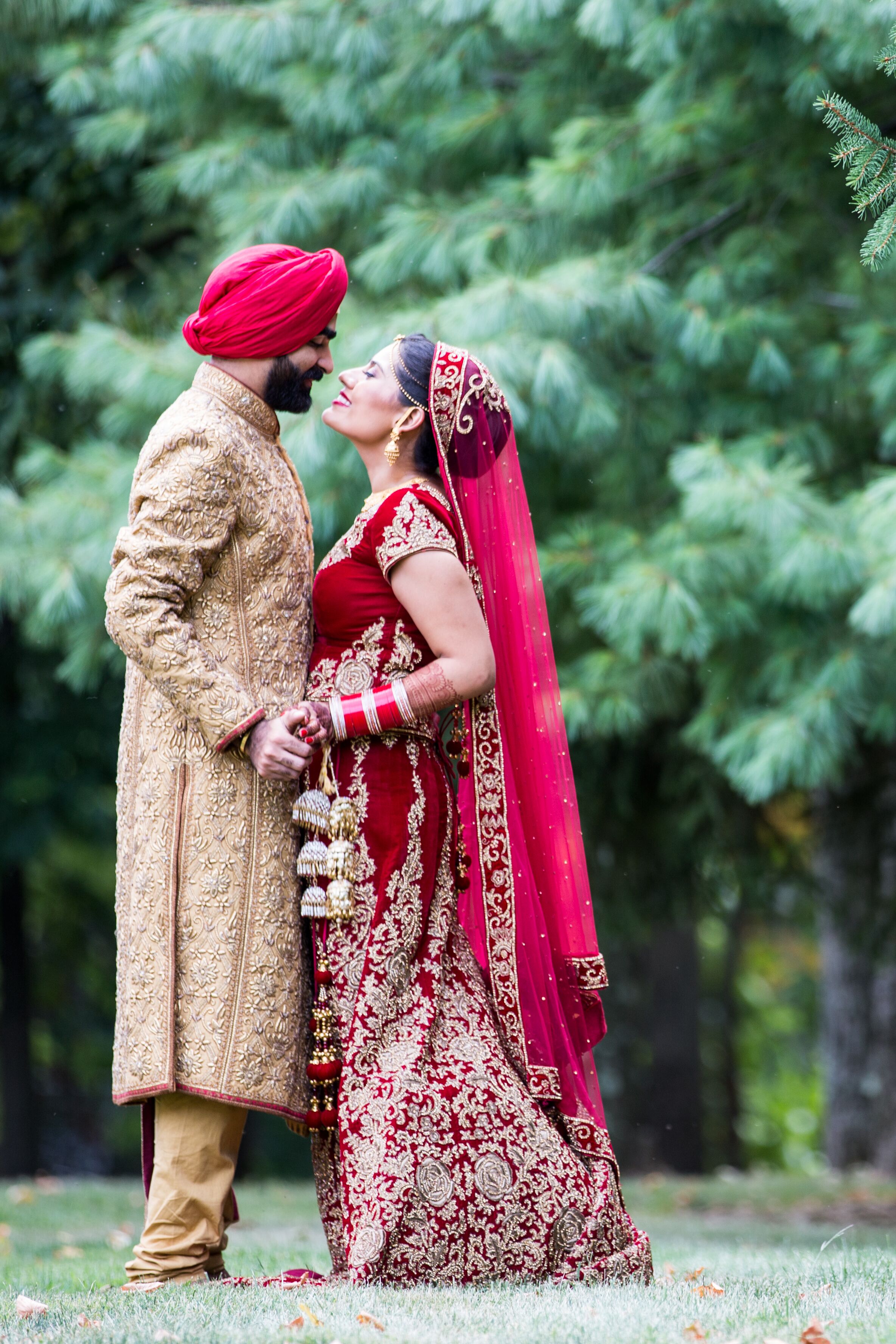 Indian Couple  in Traditional Red and Gold Wedding  Outfits