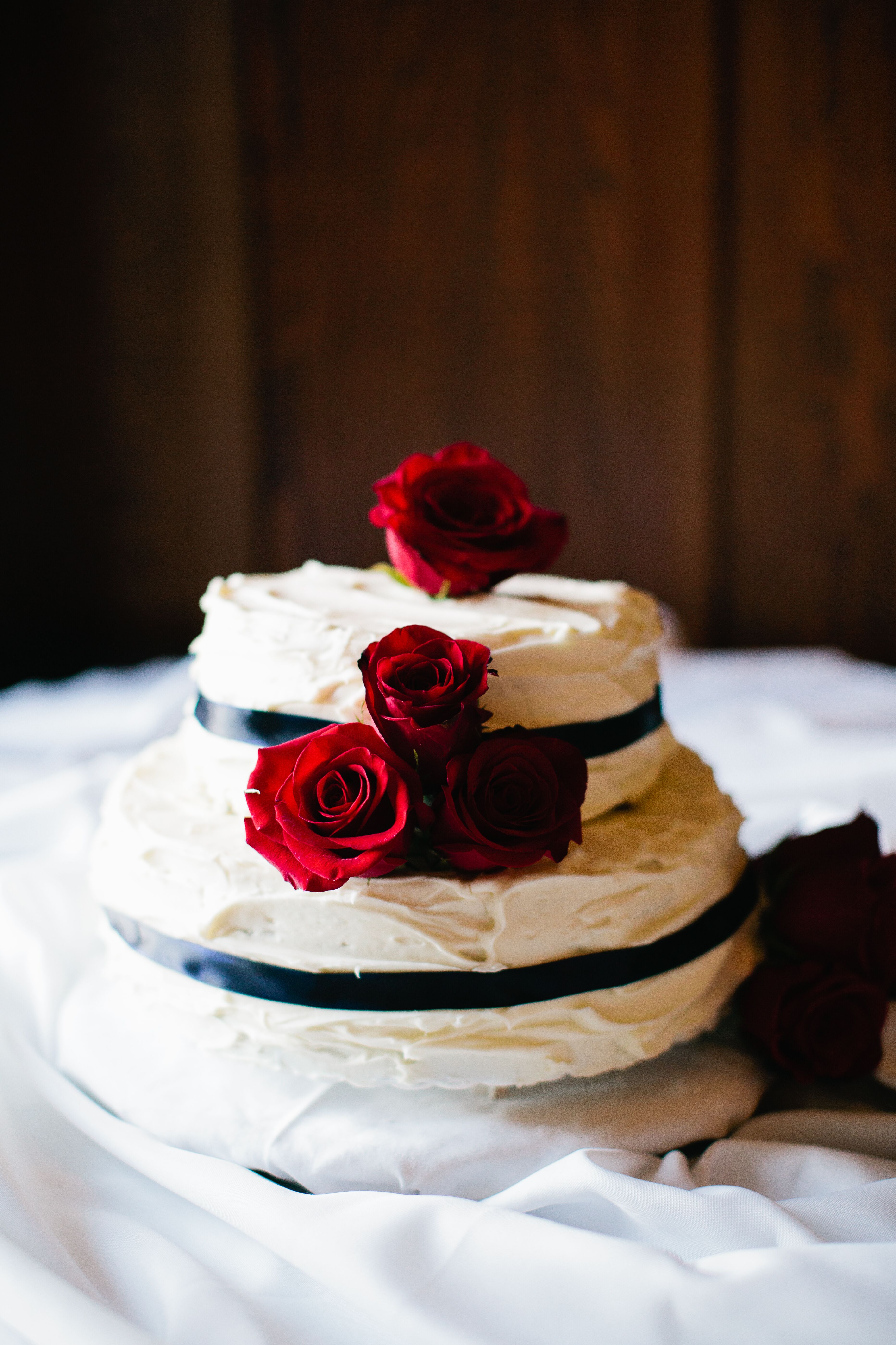 white wedding cake with red roses