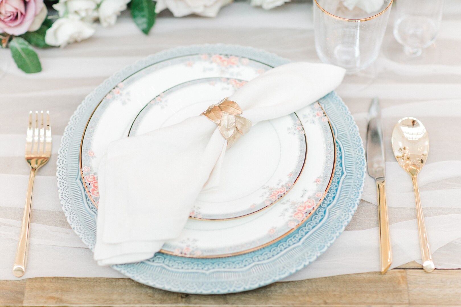 Elegant Place Setting with Patterned China and Gold Flatware