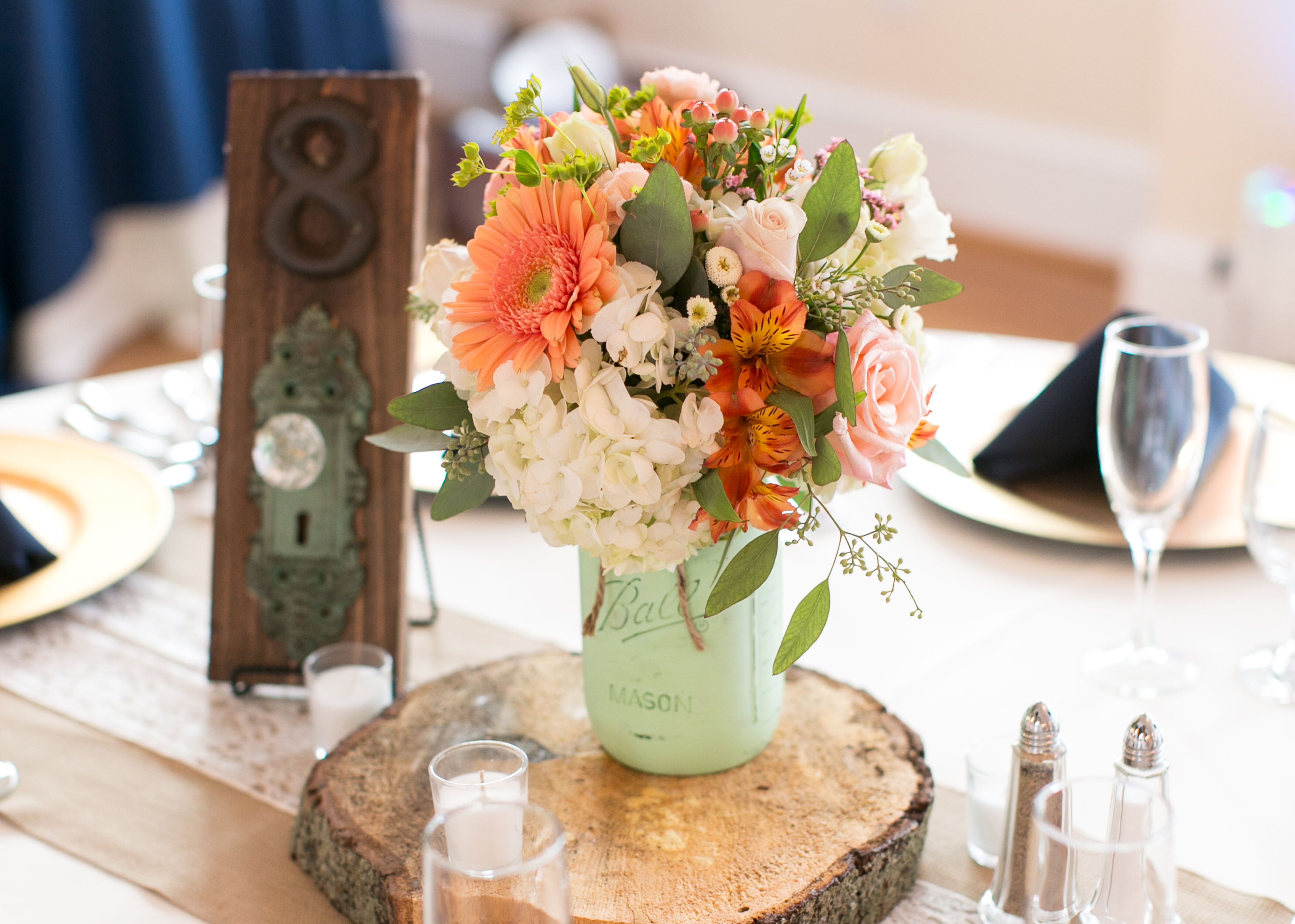 Wood Slab Centerpieces With Mint Mason Jars And Doorknob Table Numbers