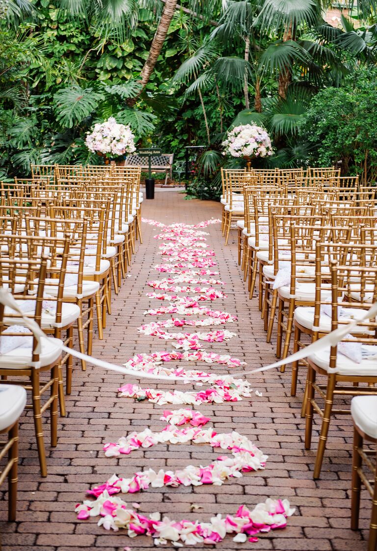 Wedding ceremony aisle lined with flower petals