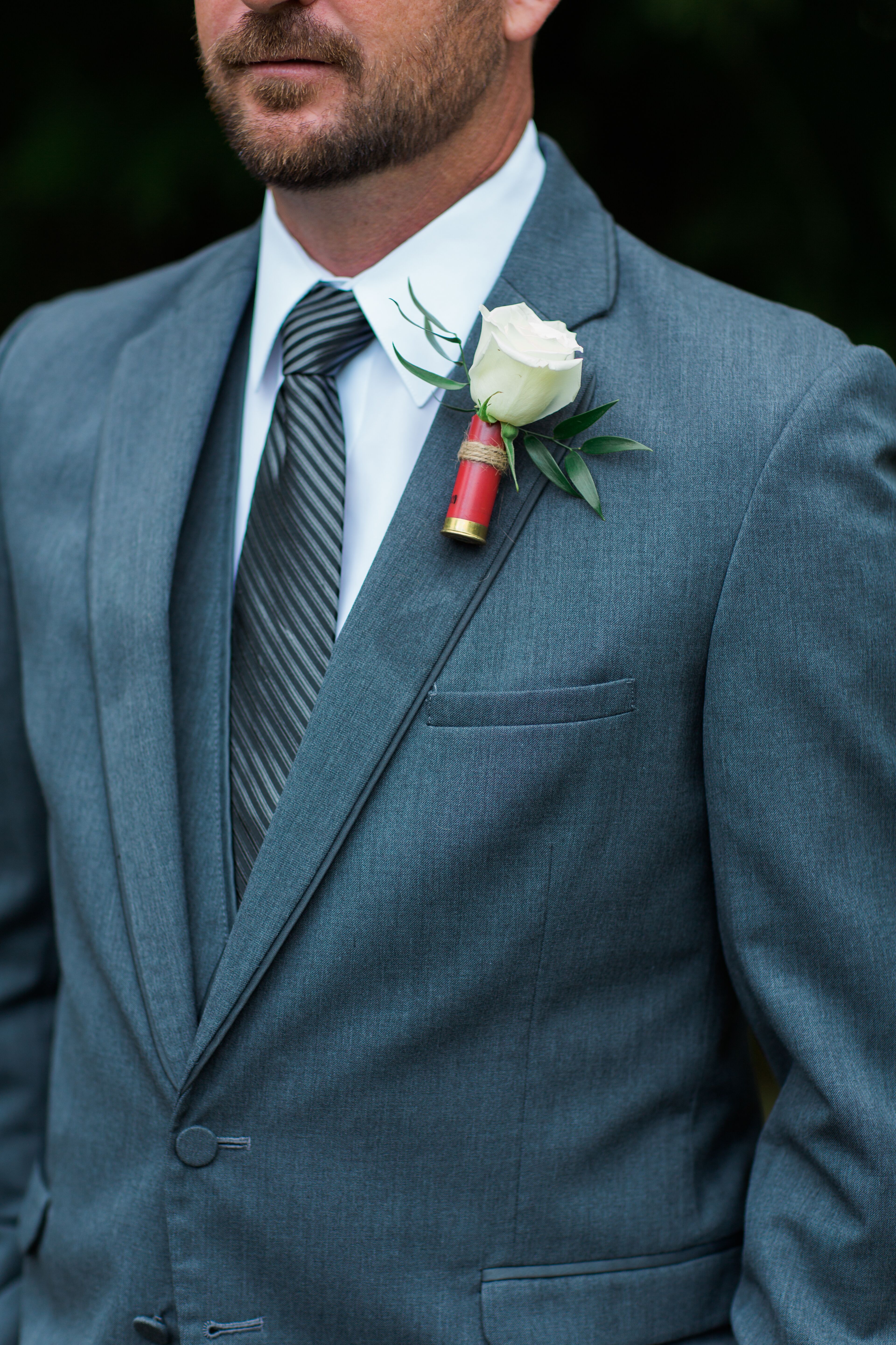 White Rose Boutonniere With Red Holder