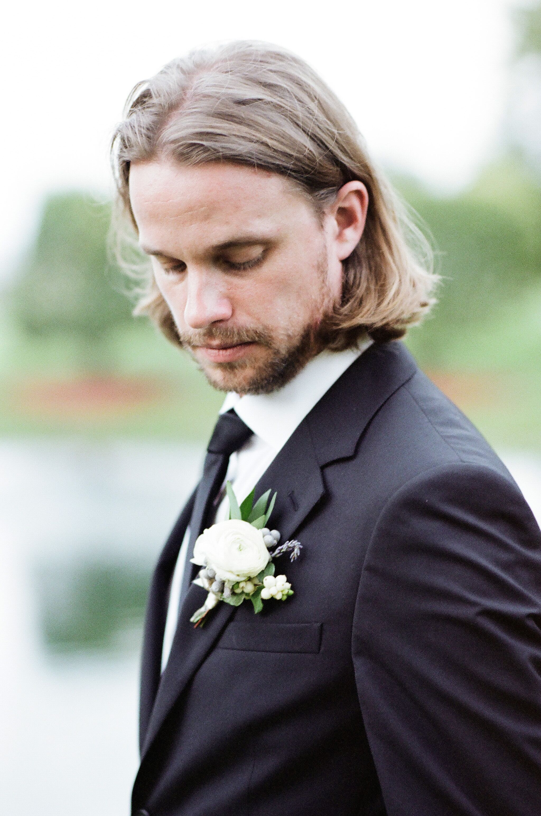 Classic Black Prada Suit with White Boutonniere