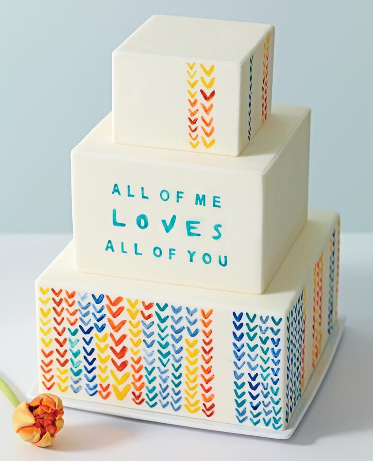 Three Tiered Cream Cake With Song Lyrics and Watercolor Hearts