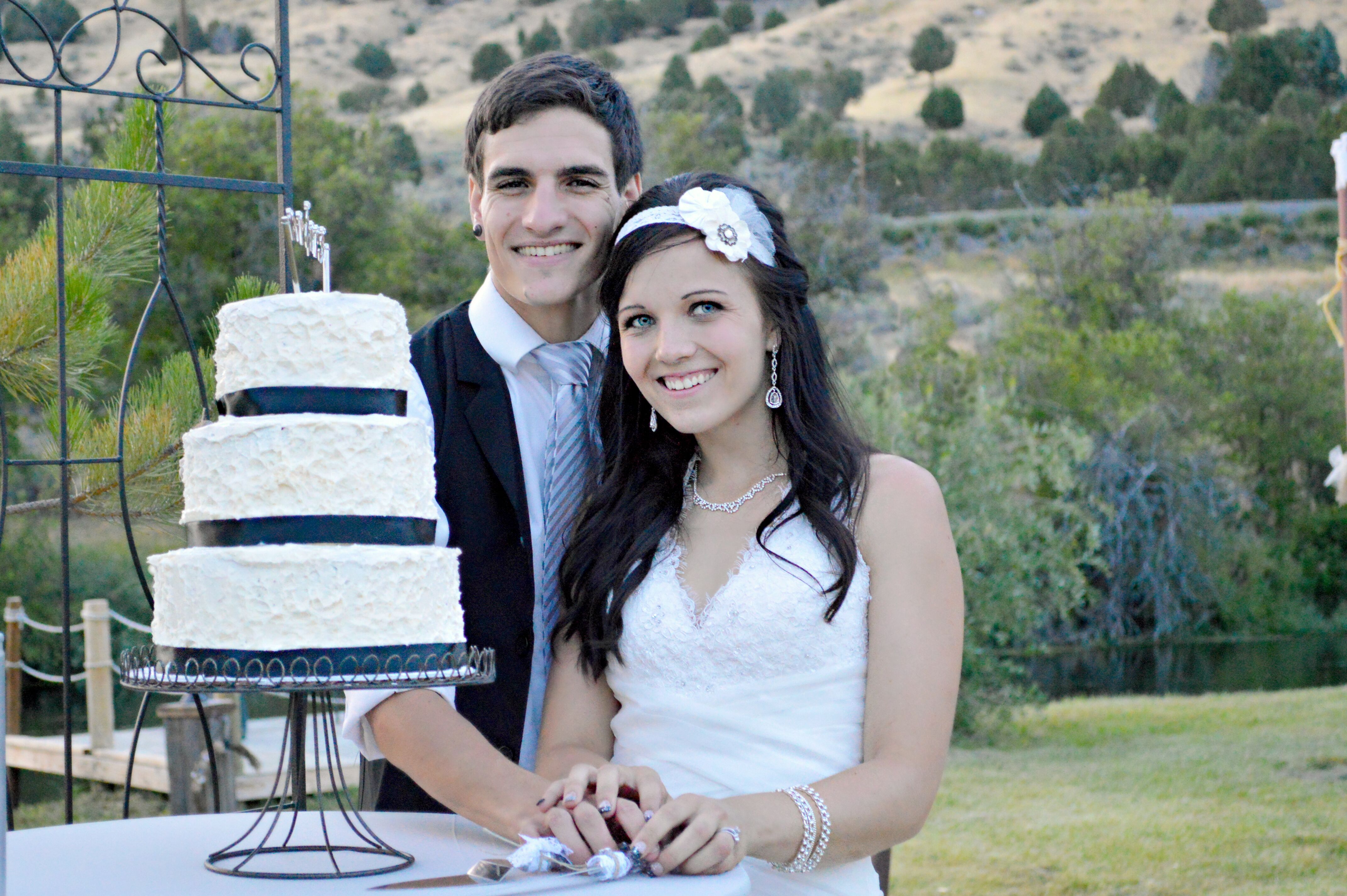 Tiered White Wedding Cake With Black Ribbon