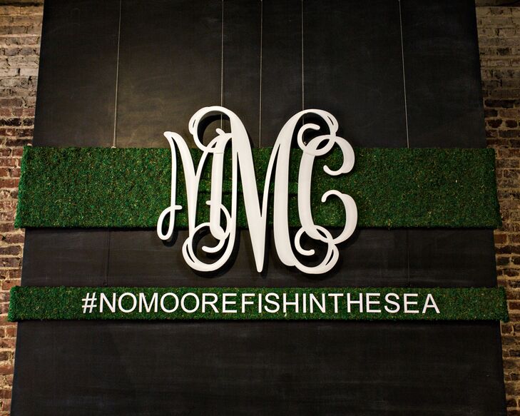Moss backdrop with monogram and hashtag
