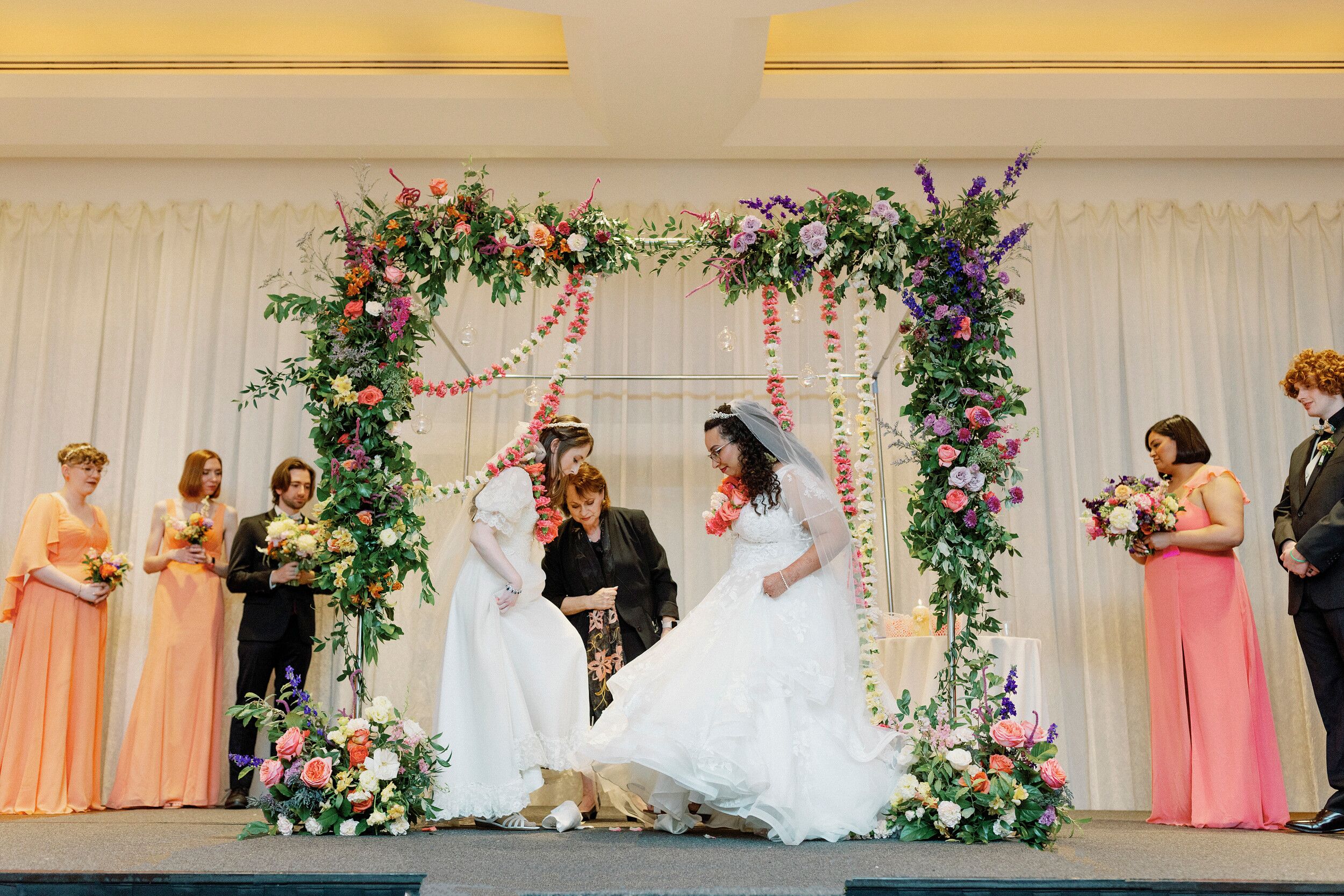 Brides Breaking The Glass Under Chuppah At Same Sex Jewish Wedding Ceremony   5d7dcc30 8e4f 11ee B291 Fbd6d8ac2c1e