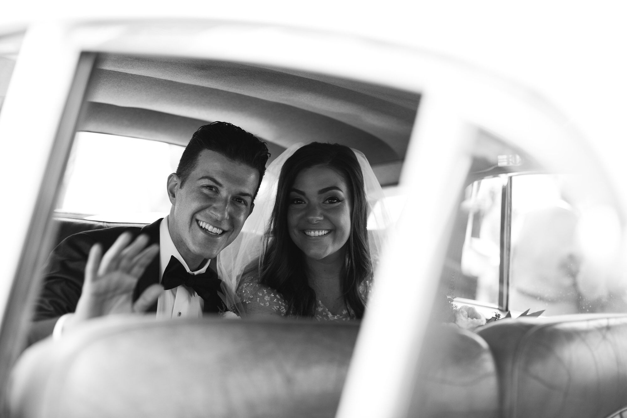 Bride and Groom Leave the Ceremony in Vintage Rolls-Royce