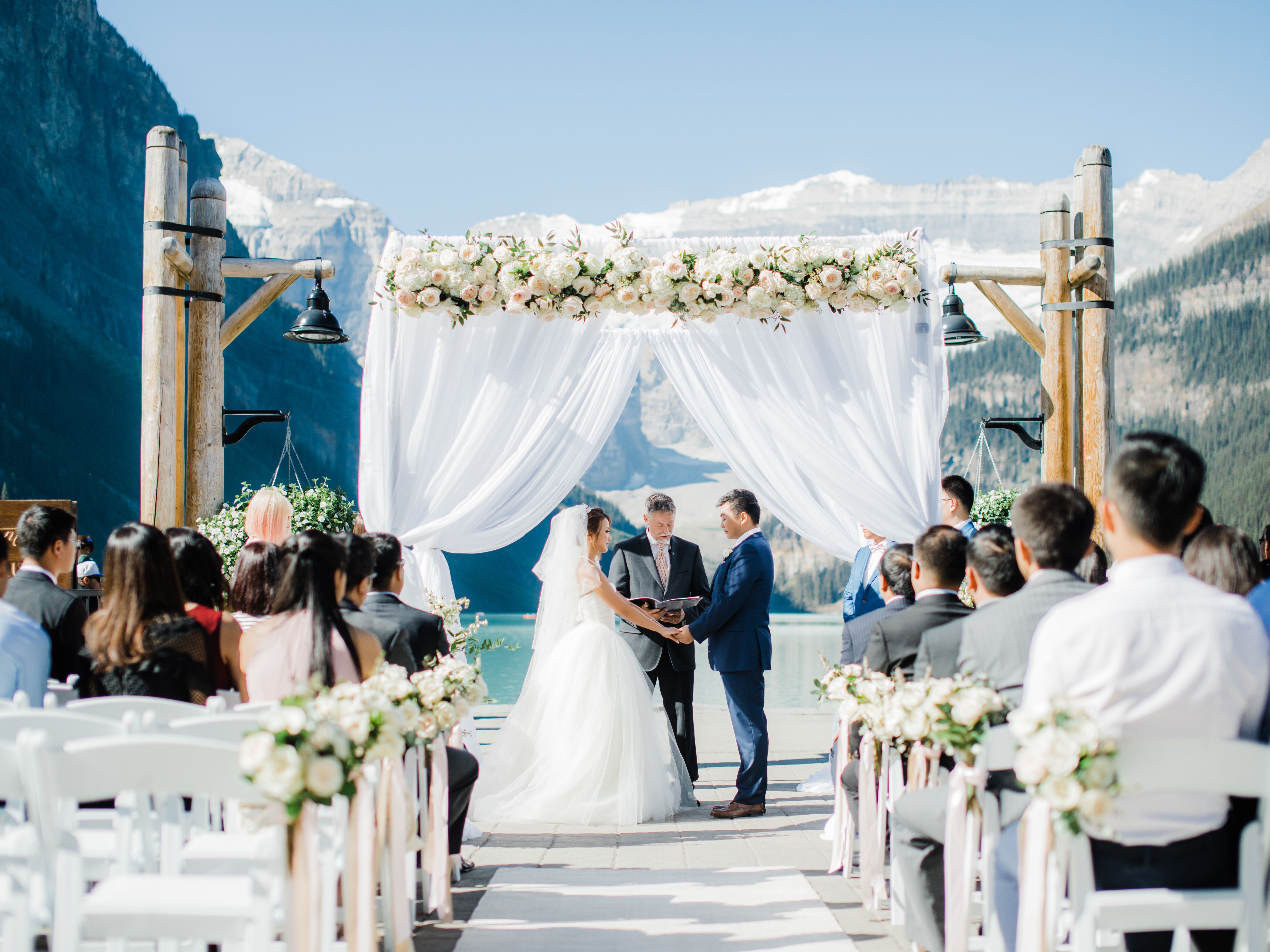 Wedding Arch Draped in Romantic Fabric and Garden Roses