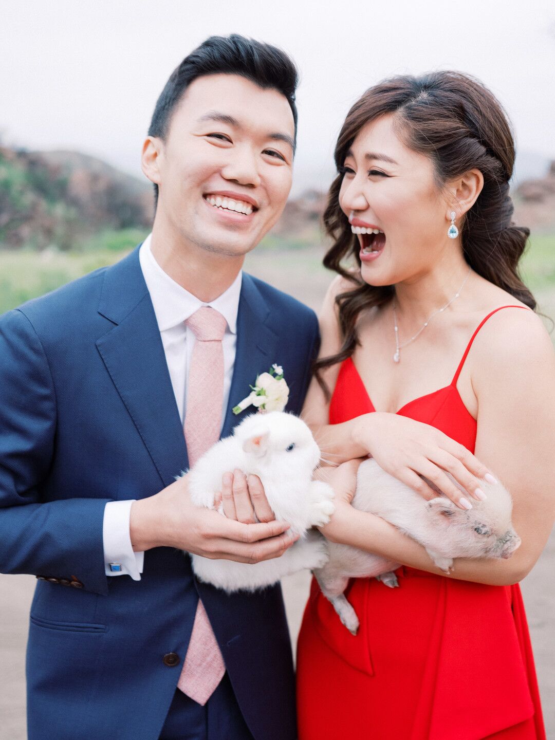 elegant-couple-with-navy-suit-red-dress-and-animals