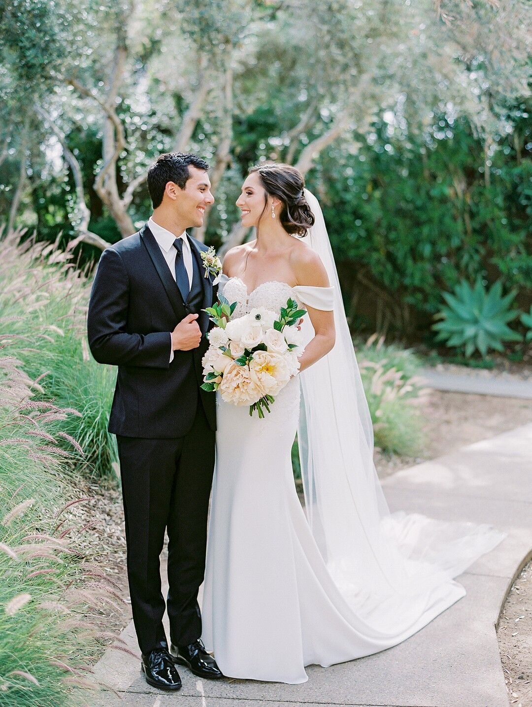 Romantic Couple with Black Tuxedo and Elegant Off-the-Shoulder Dress
