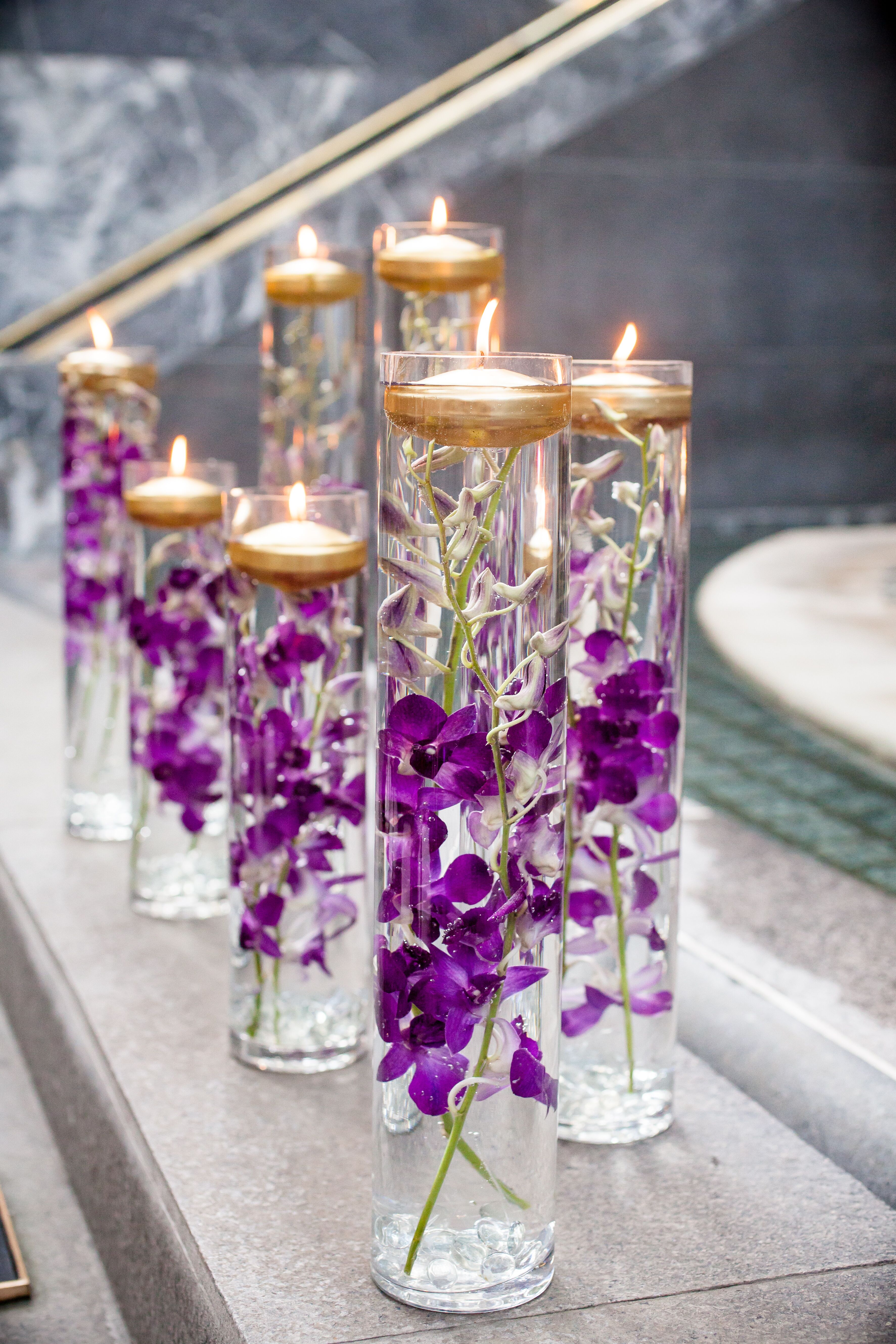 Glass Vases With Purple Orchids and Floating Candles