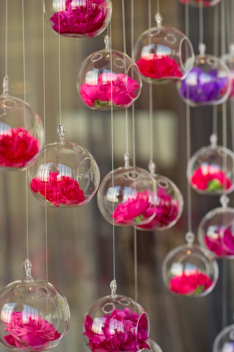 Hanging glass globe vases at wedding ceremony